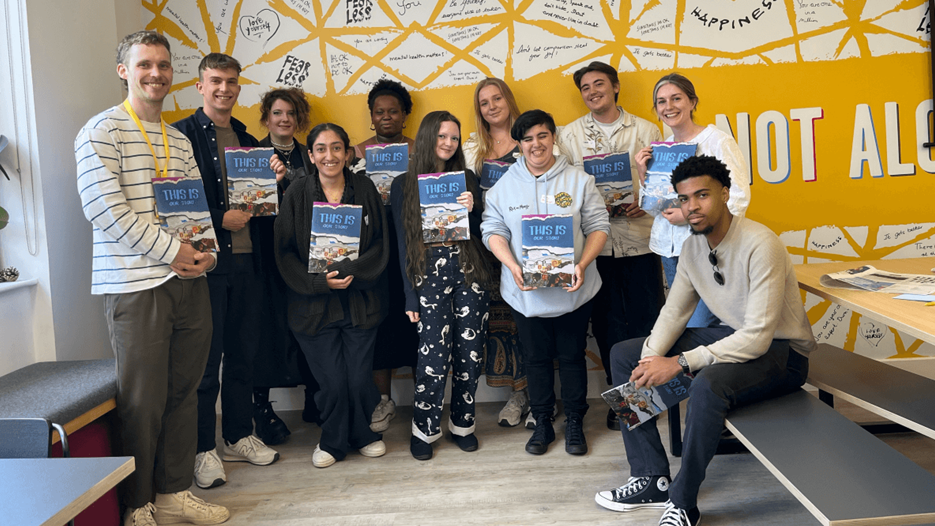 Participants from the Writers Programme 2022-23 standing and holding copies of their zine.