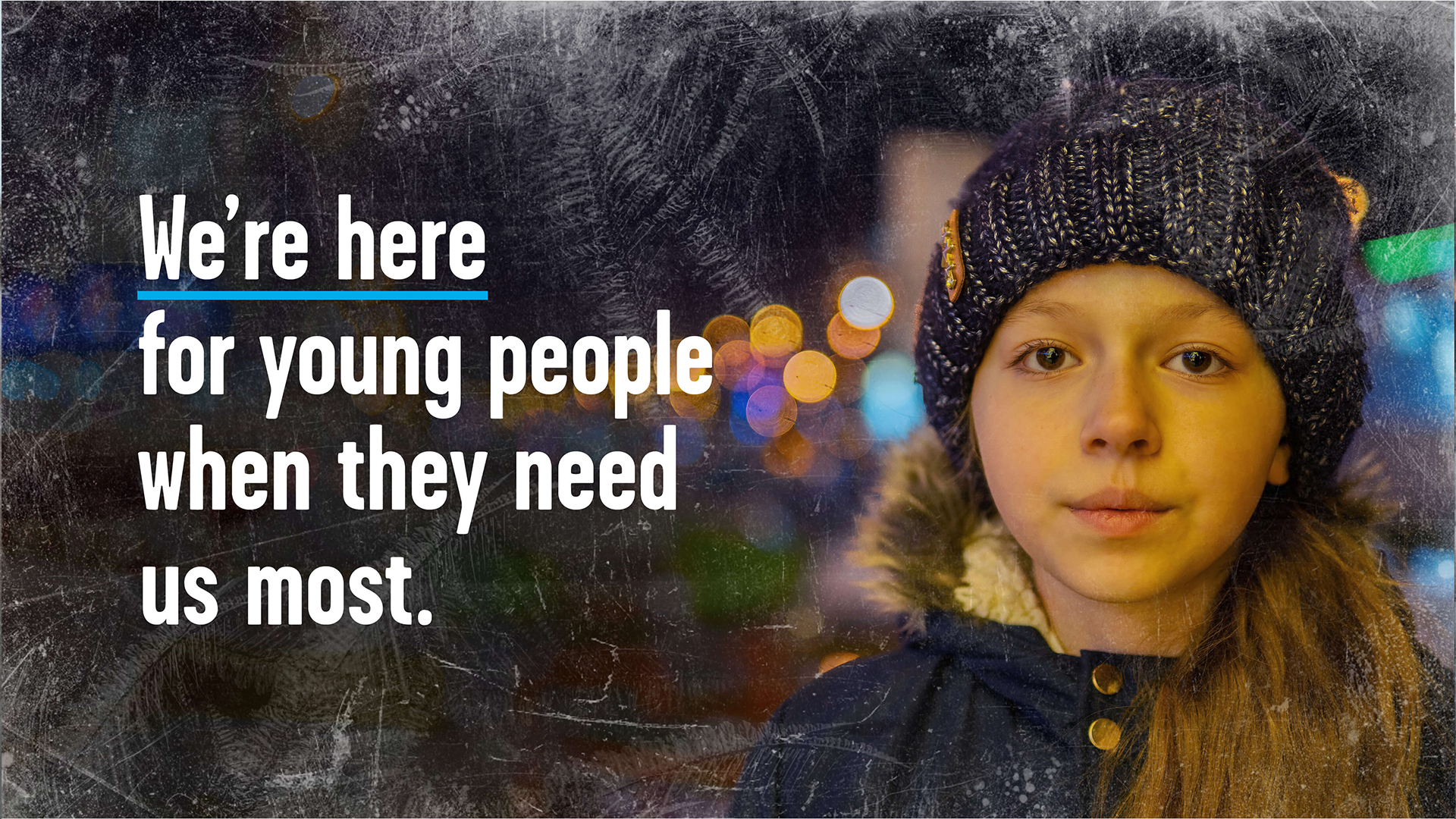 A young girl wearing a woolly hat and coat looking at the camera. Text reads: 'We're here for young people when they need us most.'