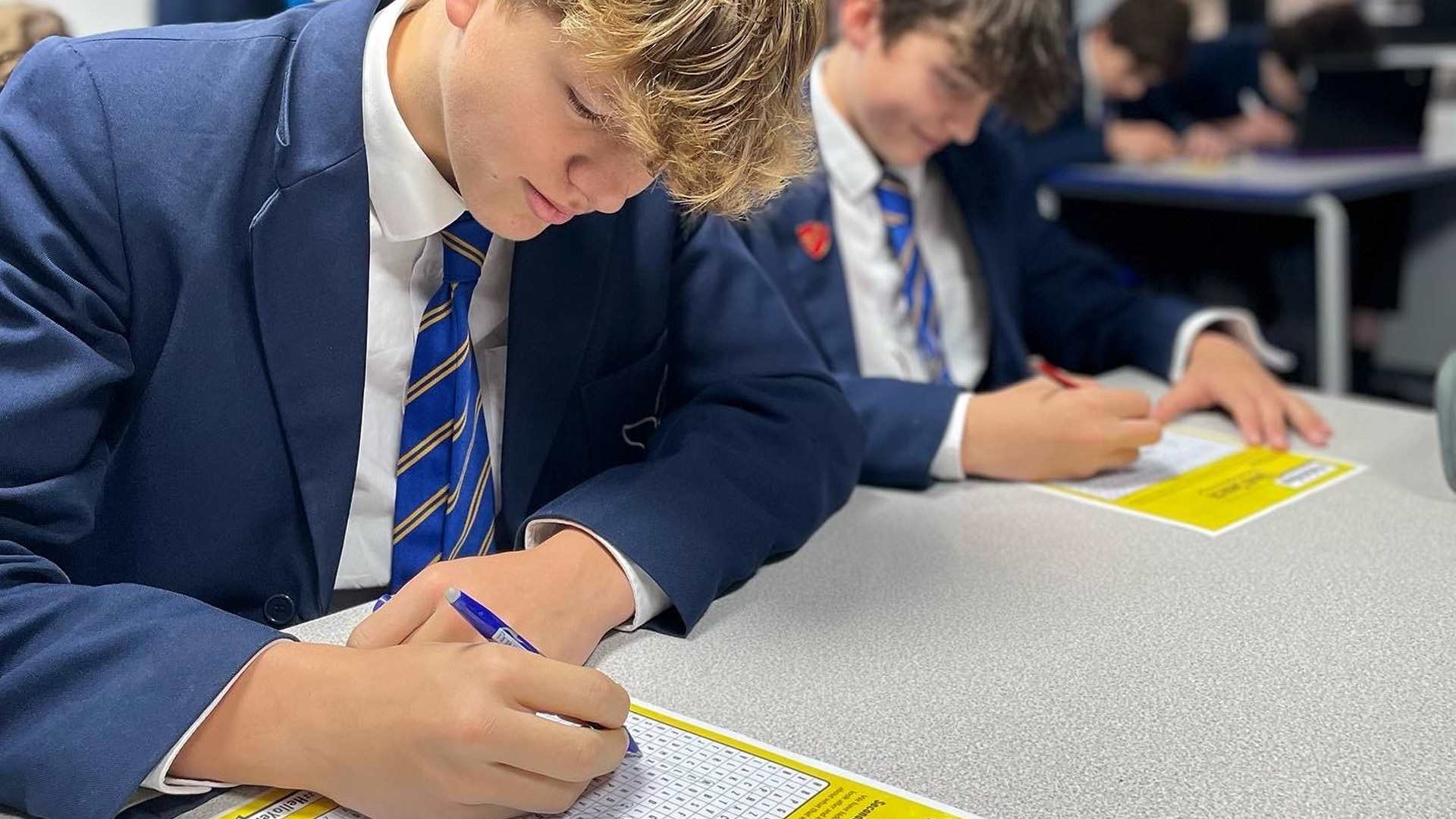 A secondary school student completing a #HelloYellow word search.