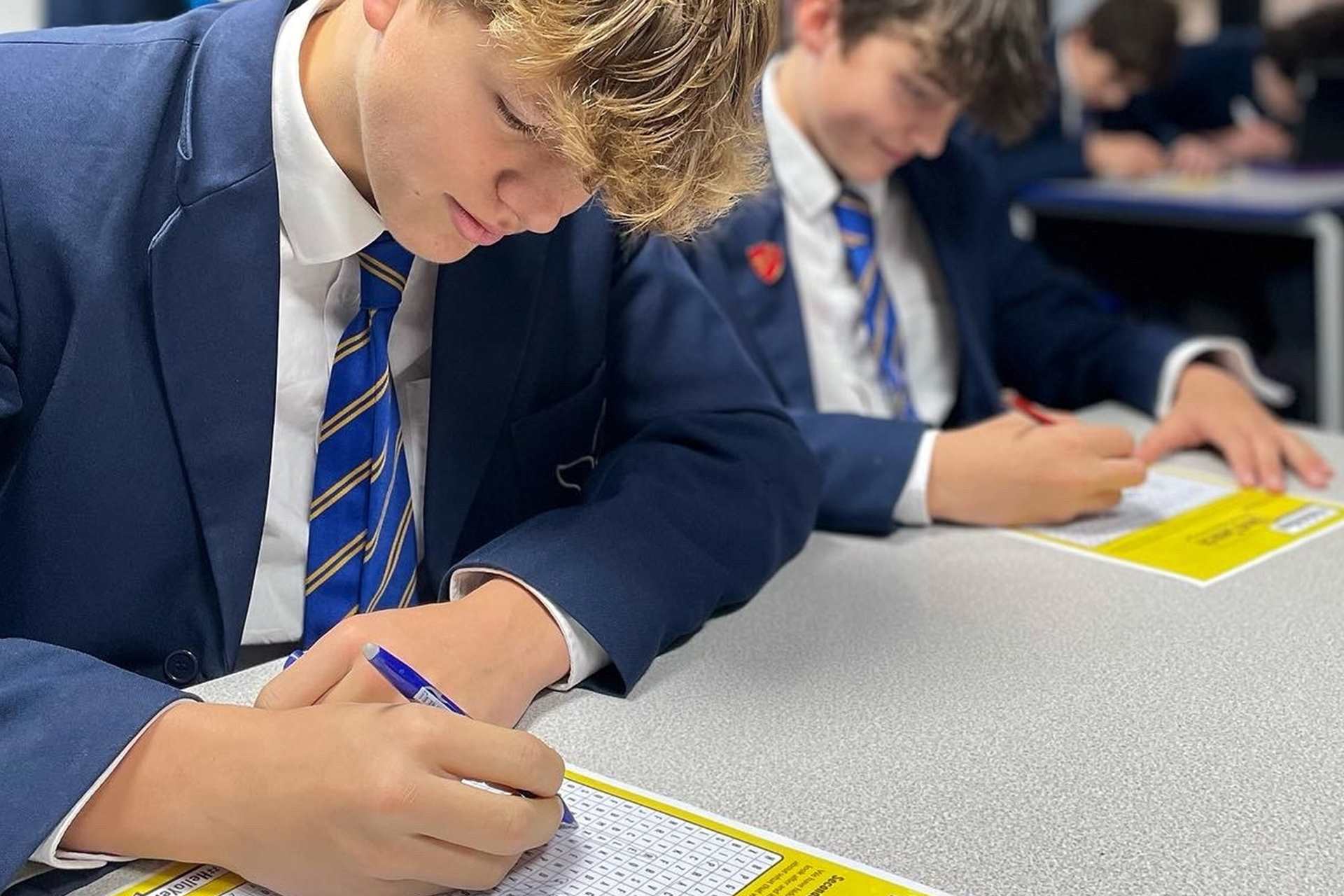 A secondary school student completing a #HelloYellow word search.