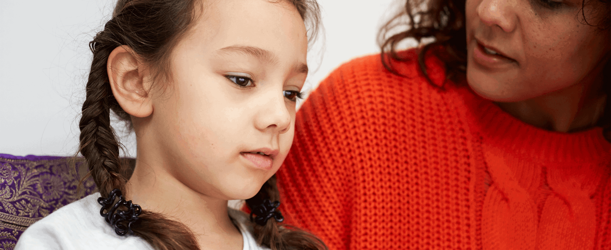 A mother and daughter talking on the sofa