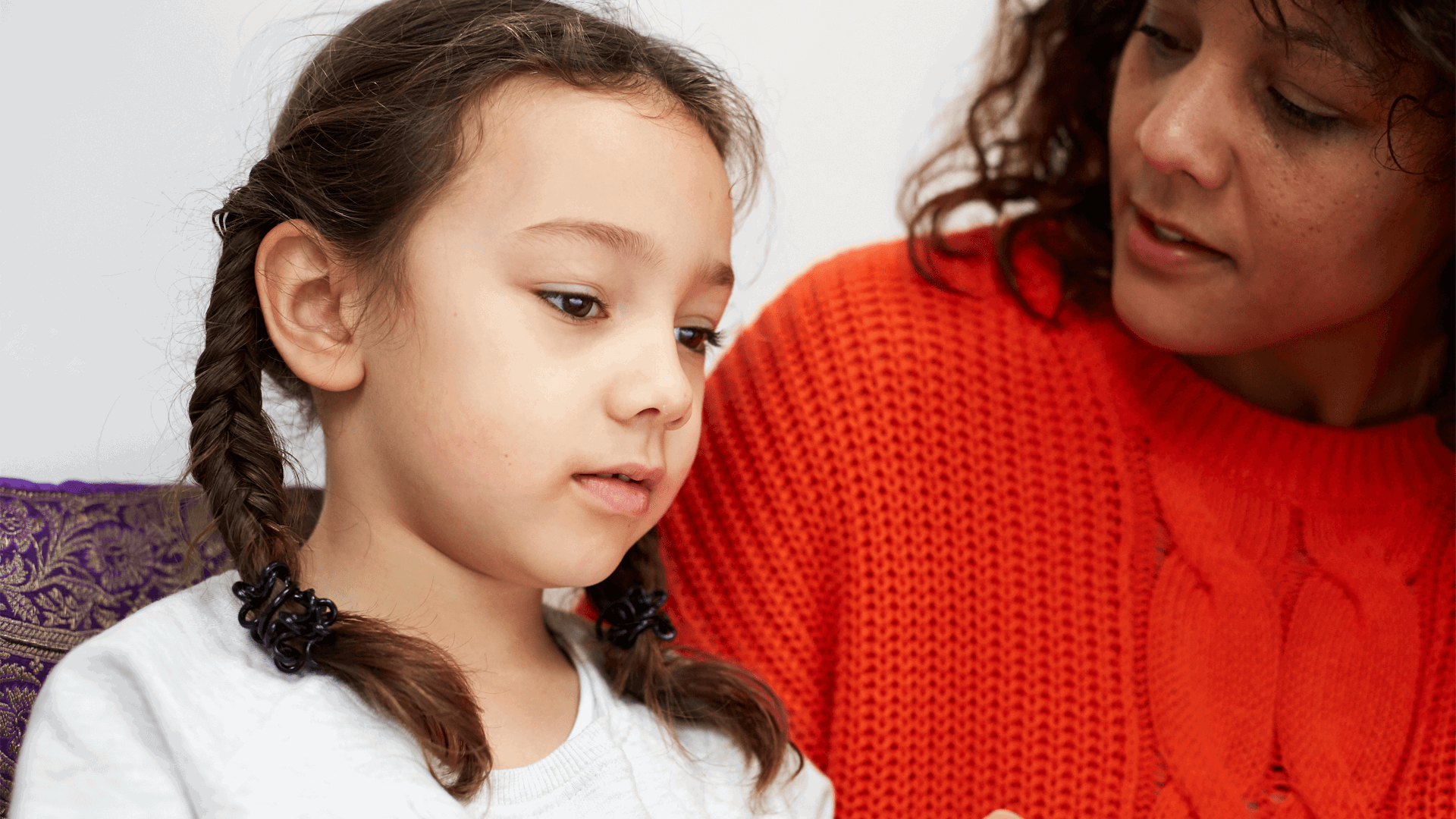 A mother and daughter talking on the sofa