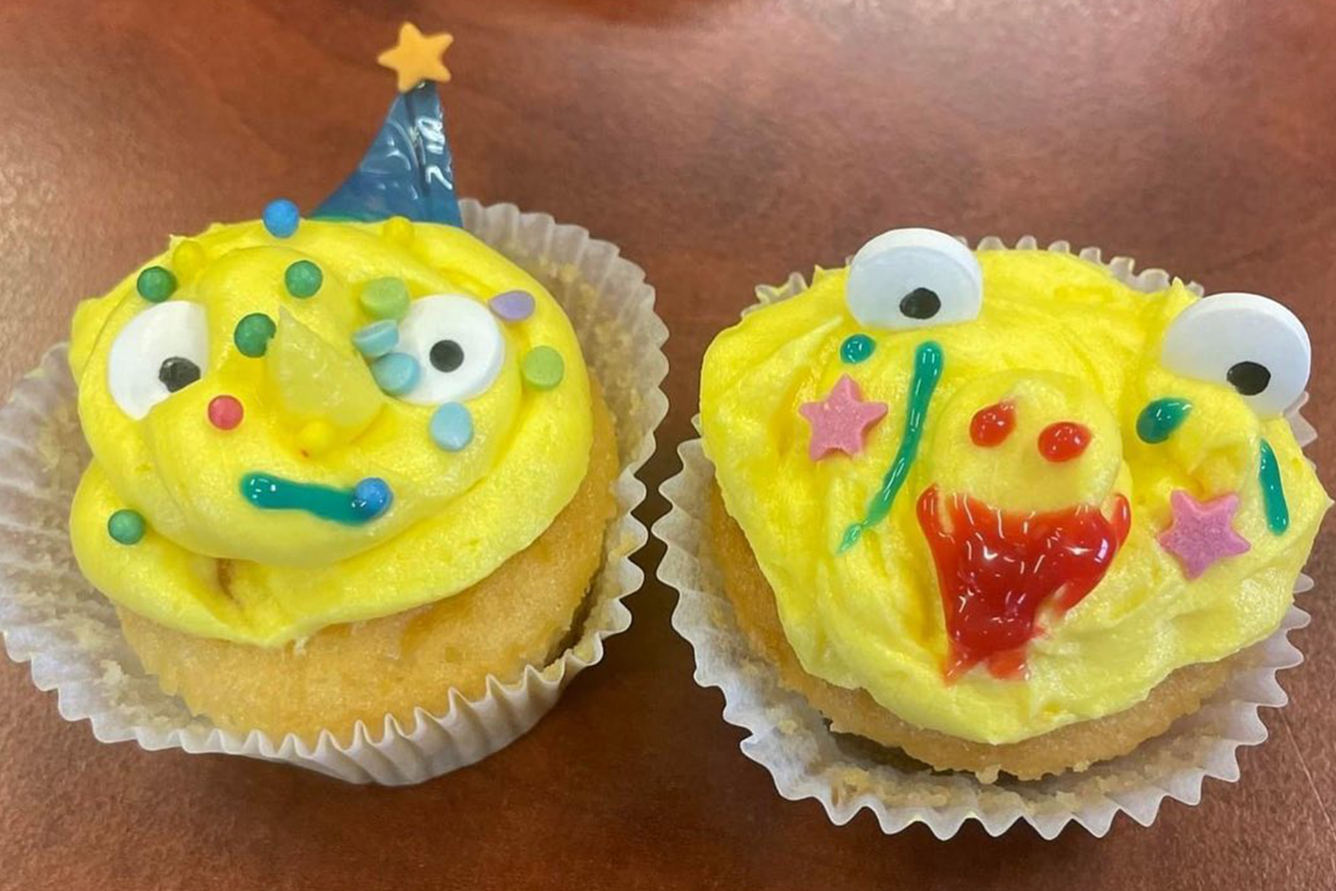 Two yellow cupcakes with faces made by students at Lathallan School.