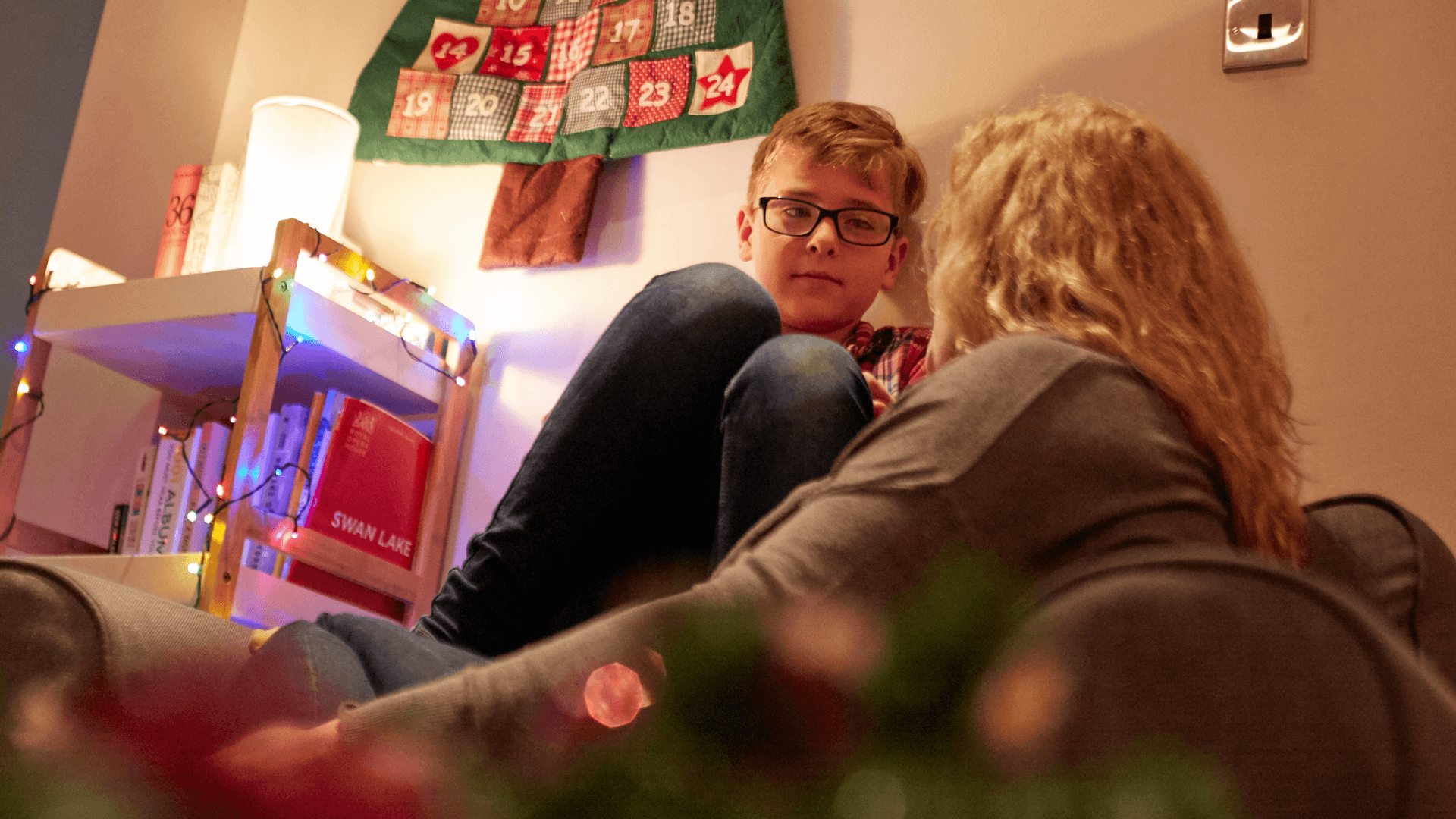 A mother in deep conversation with her young son in the lounge