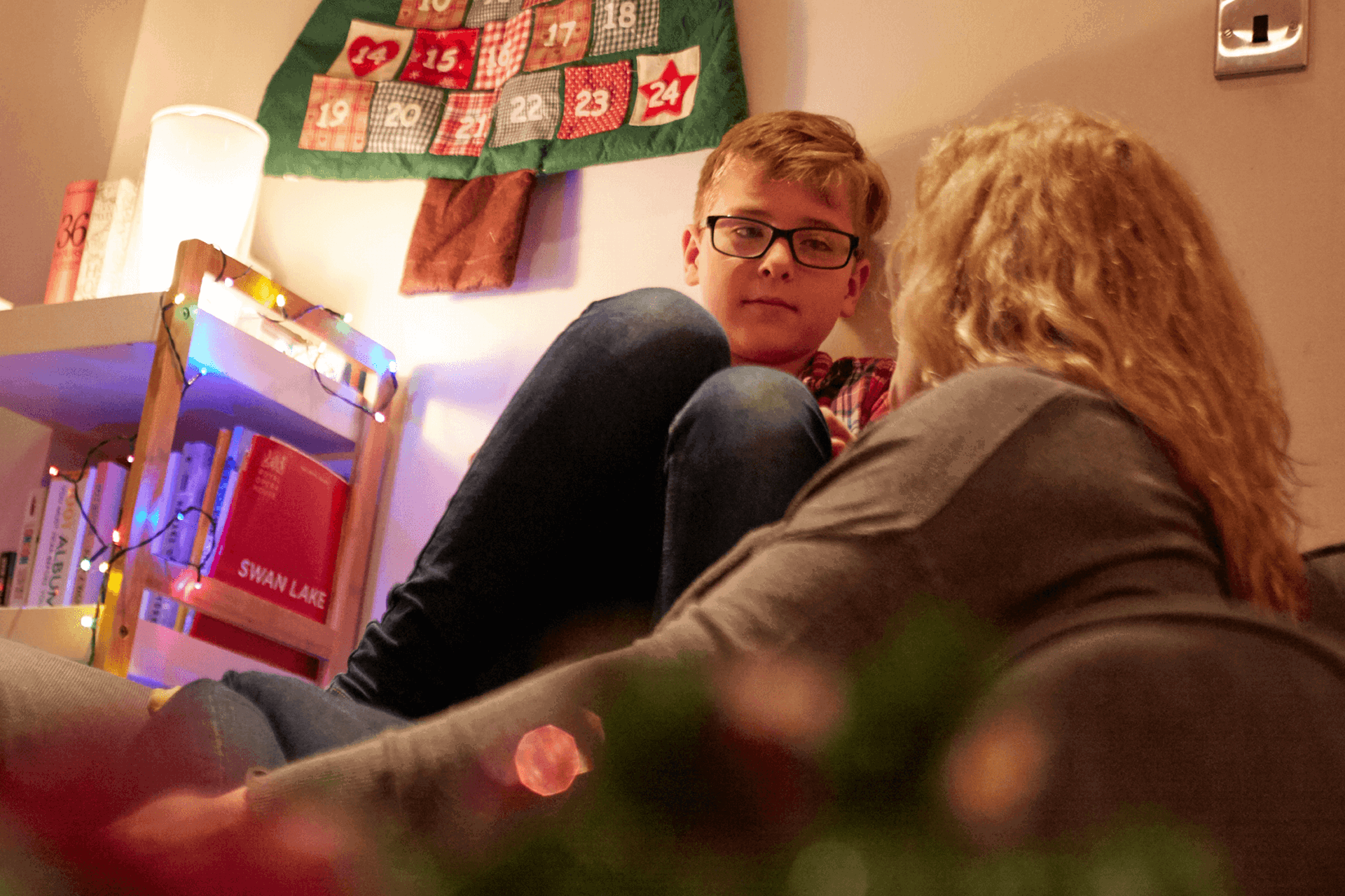 A mother in deep conversation with her young son in the lounge