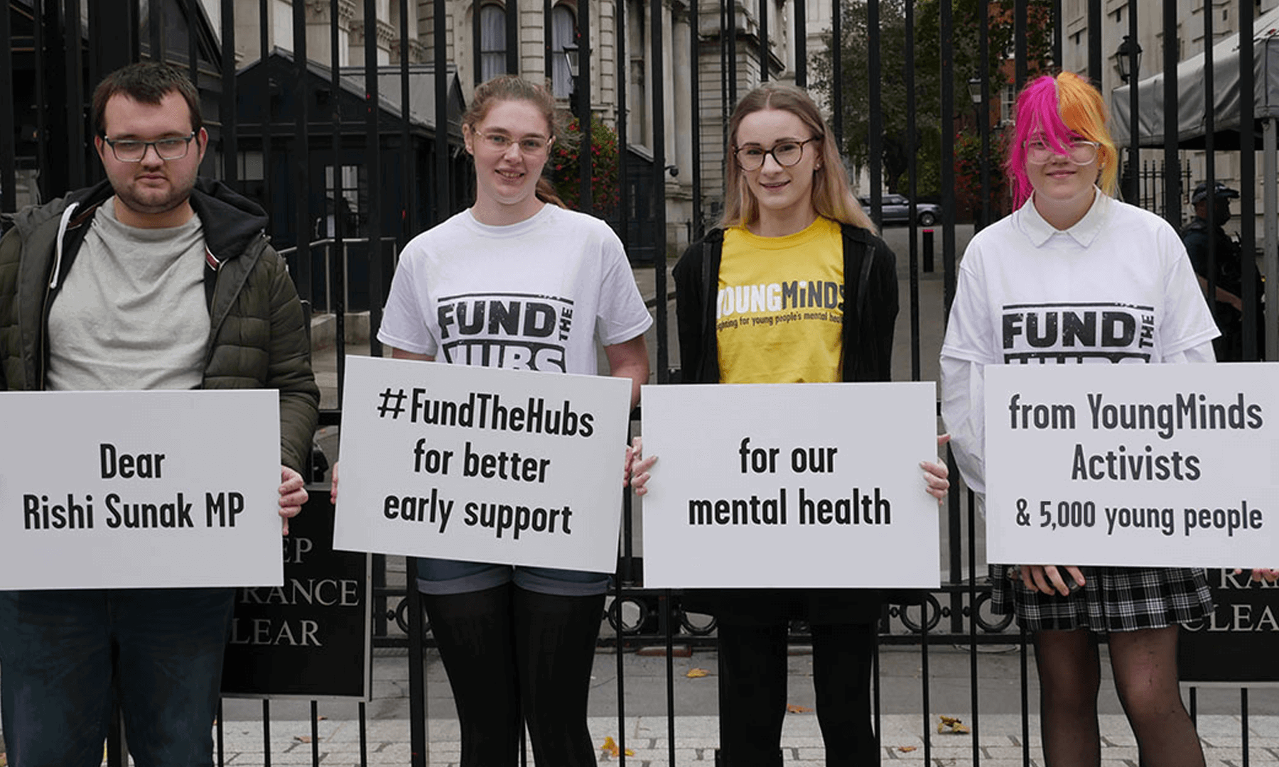 Four YoungMinds Activists at Downing Street holding placards calling for Rishi Sunak MP to Fund The Hubs