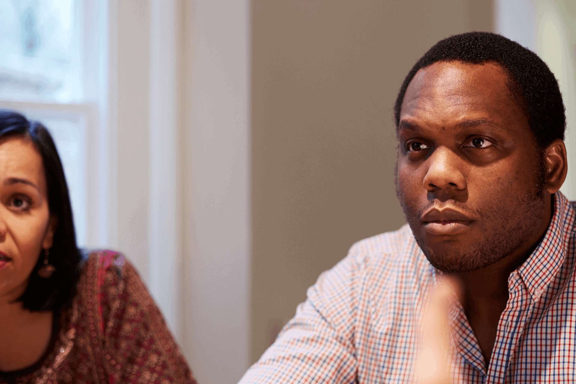 A man and woman concentrating on something in front of them