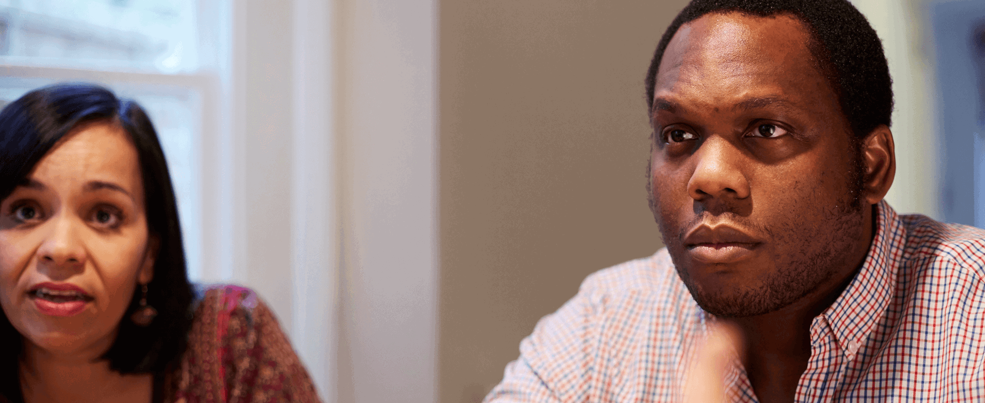 A man and woman concentrating on something in front of them