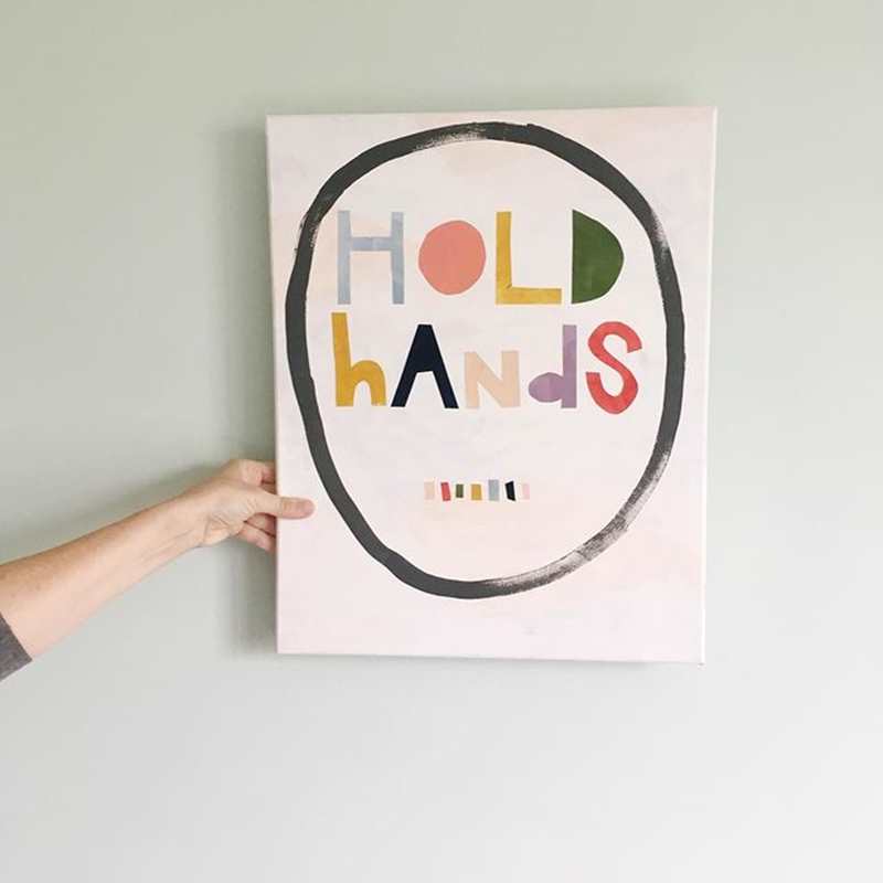 Artwork by @brookepetermann_art - The words: 'hold hands' are in a circle on a white background