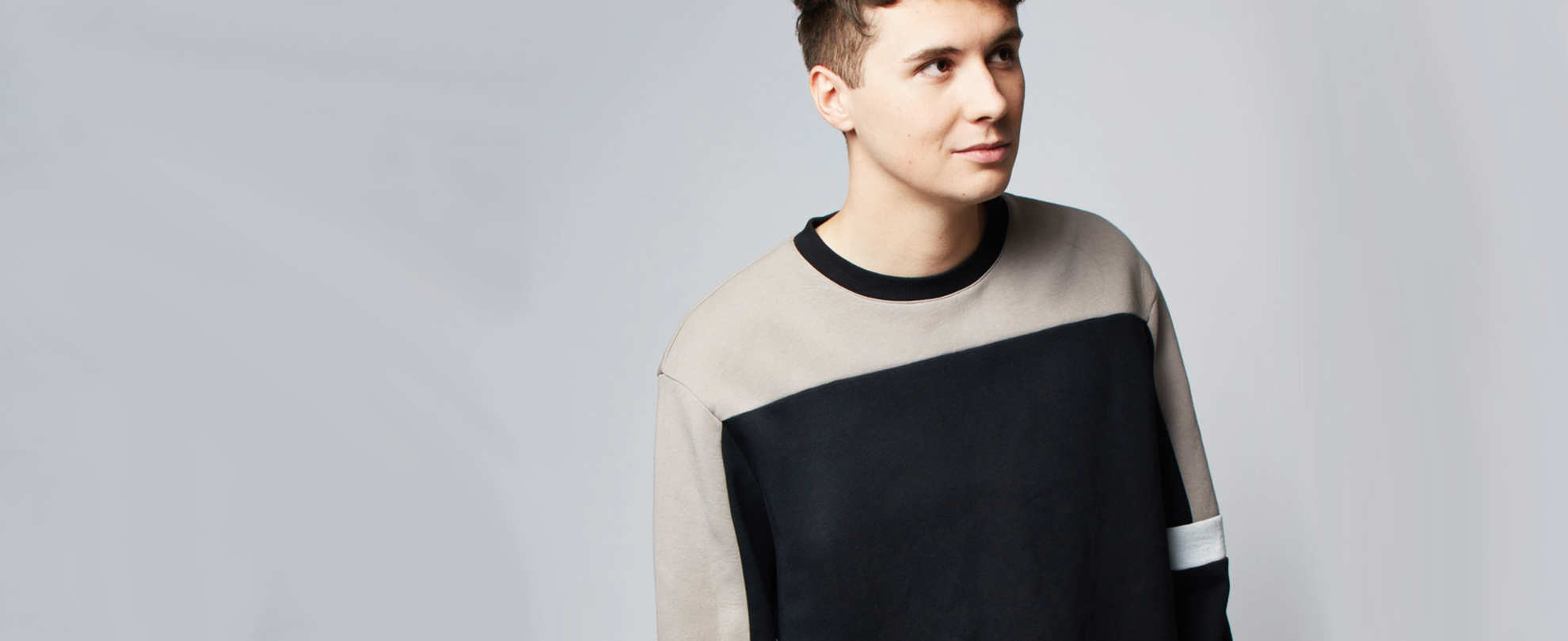 Headshot of Dan Howell against a light grey background