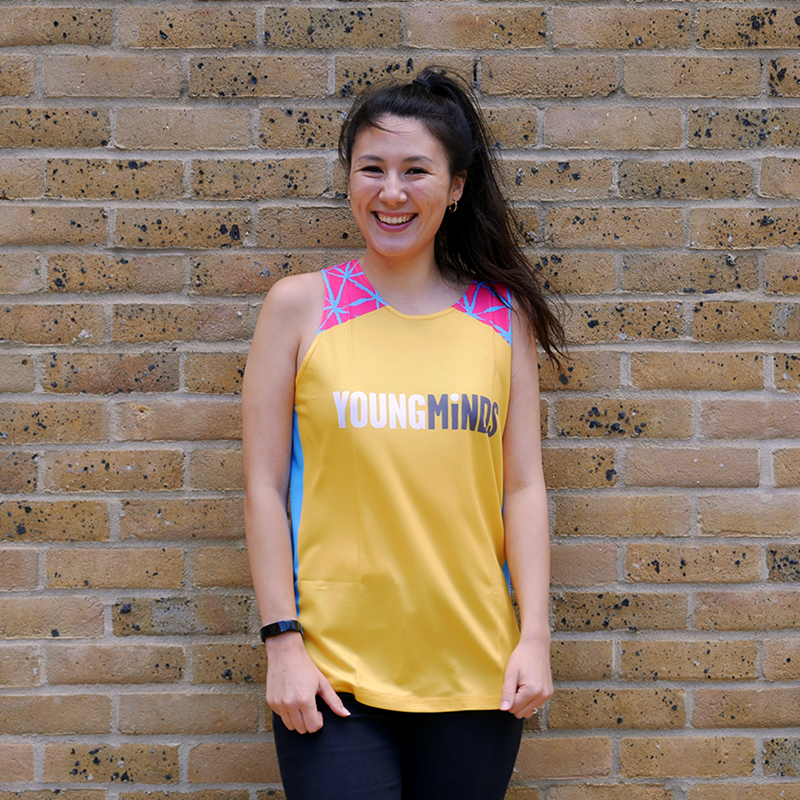 girl smiling while wearing YoungMinds running vest