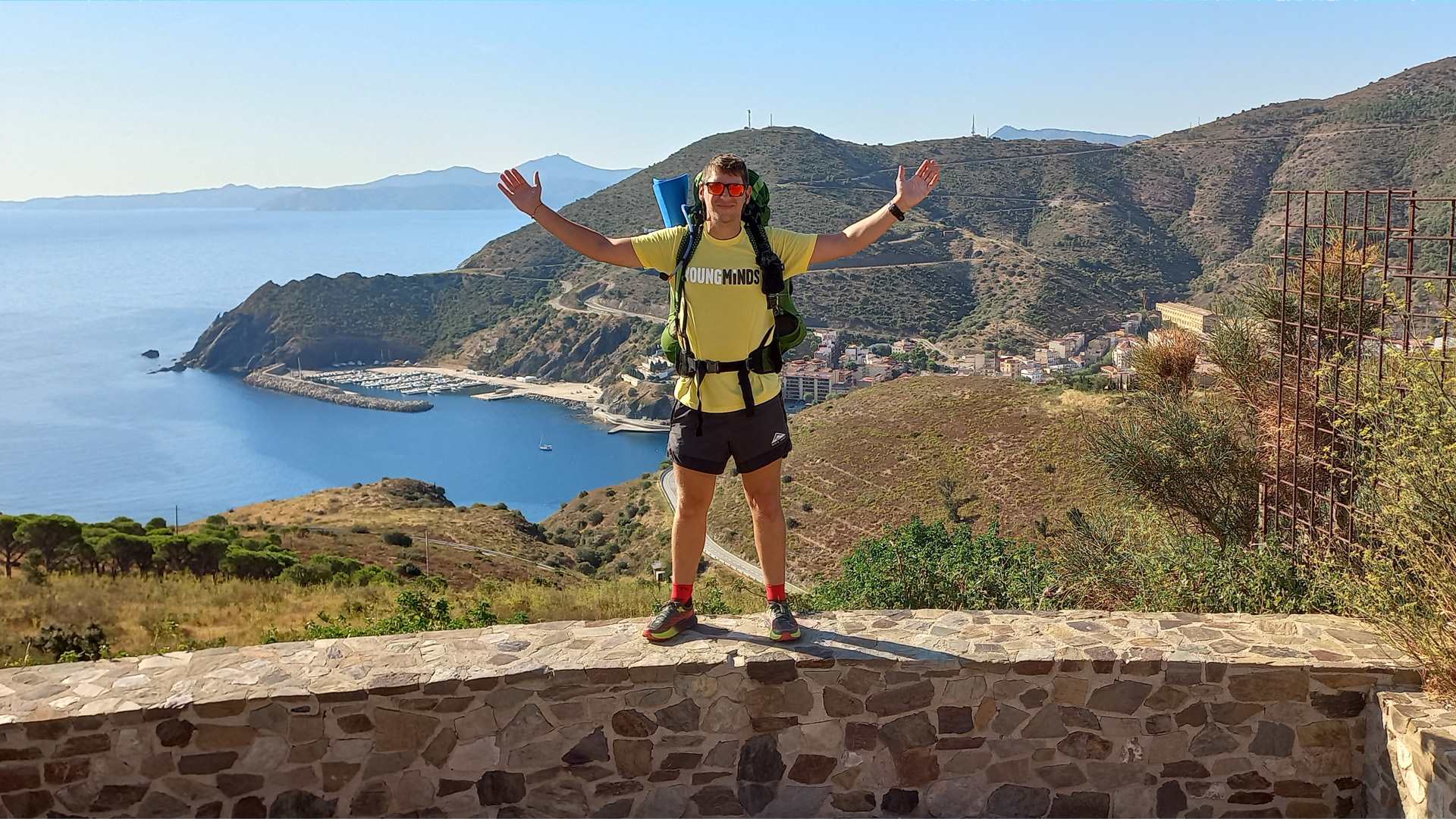 Michael Evans standing on a wall on his trip around Spain.
