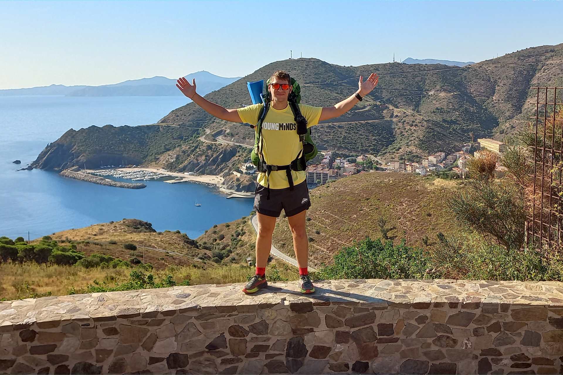 Michael Evans standing on a wall on his trip around Spain.