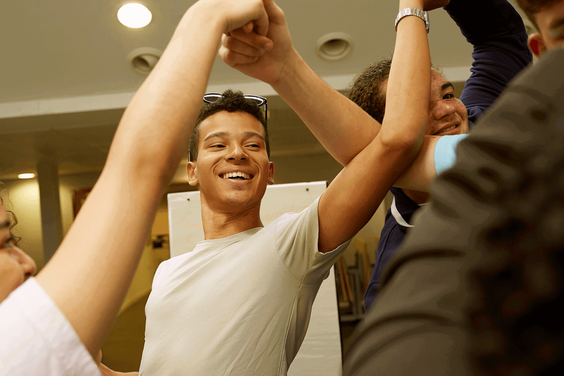 Four young people laughing and playing a game together.