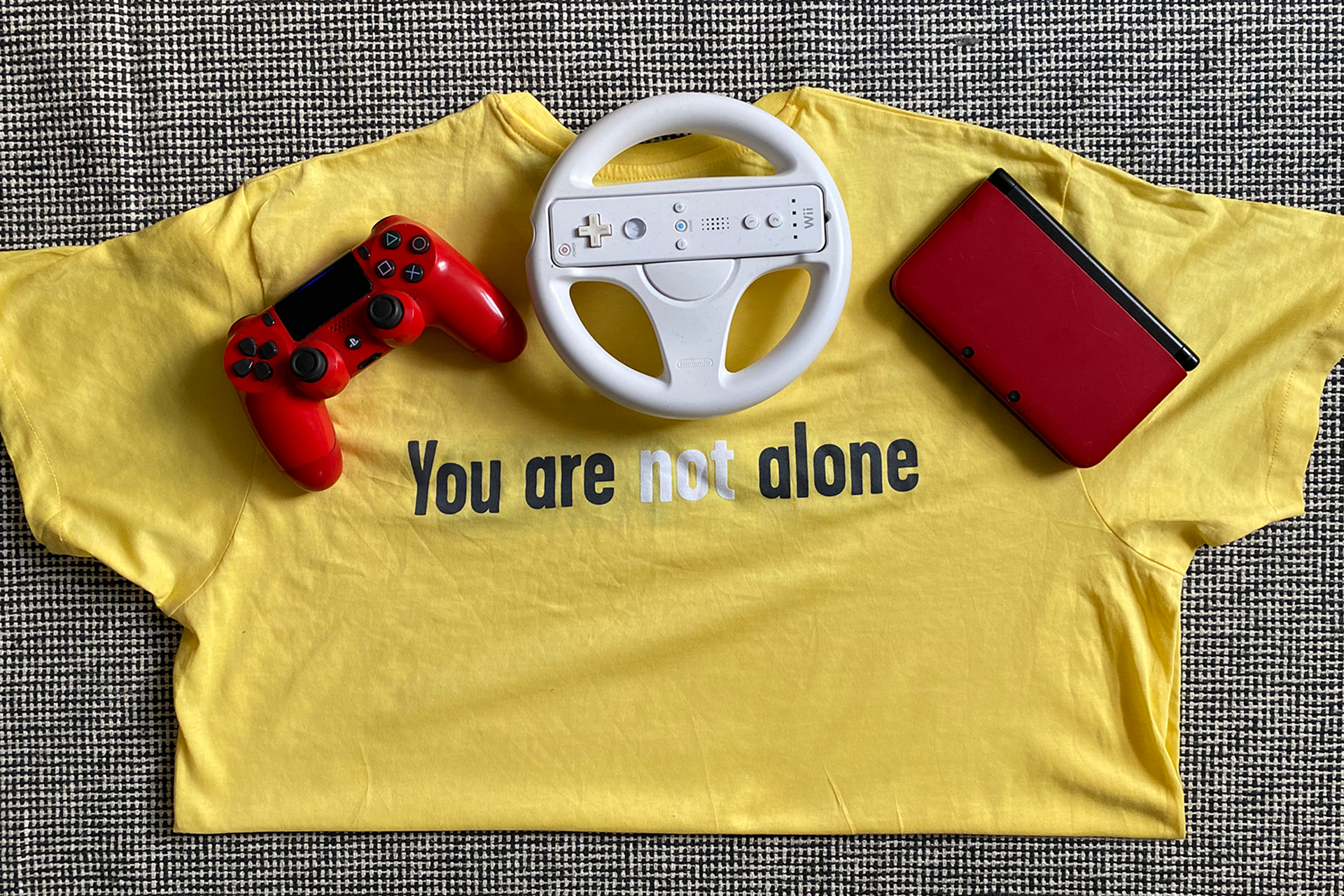 A YoungMinds t-shirt with a PlayStation controller and a Wii controller.