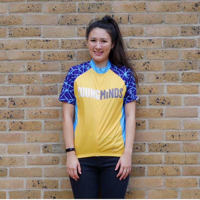a woman smiling wearing YoungMinds cycling jersey