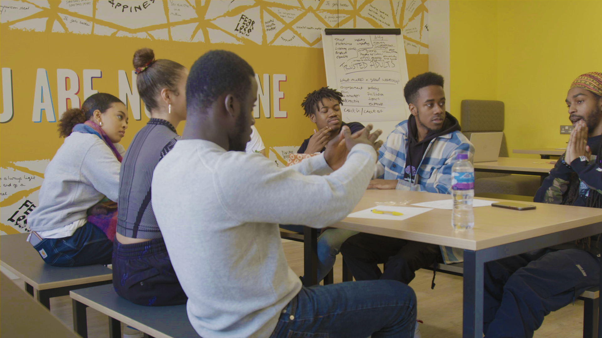 A group of young people discussing their poem ideas in the workshop.