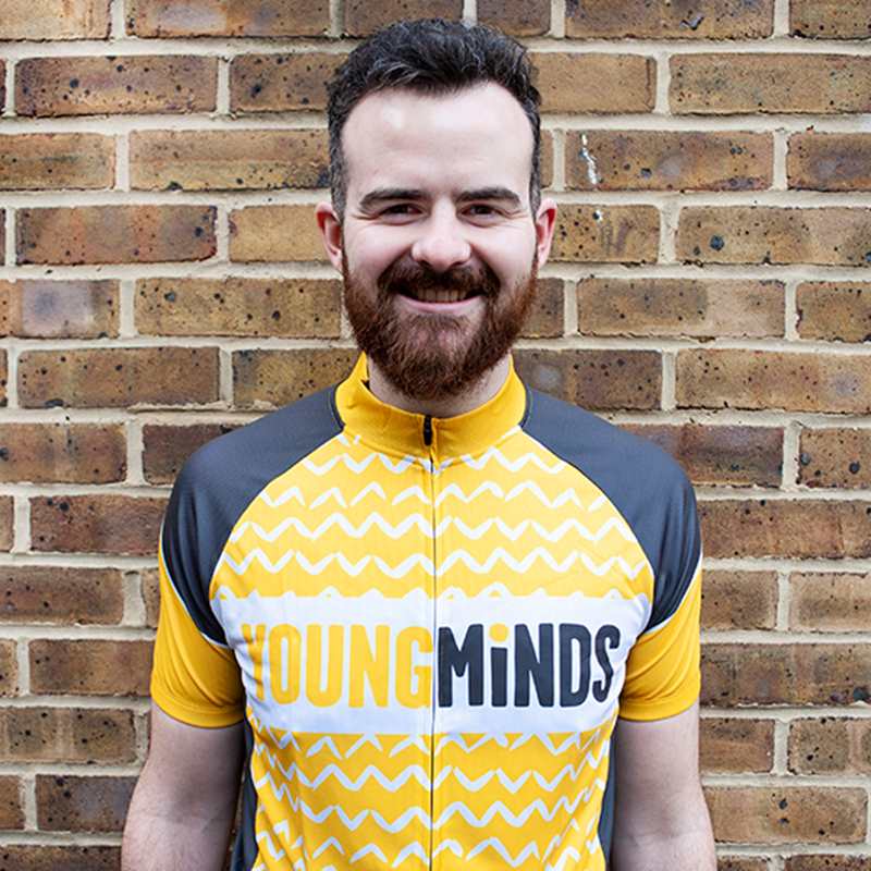 man smiling while wearing YoungMinds cycling jersey