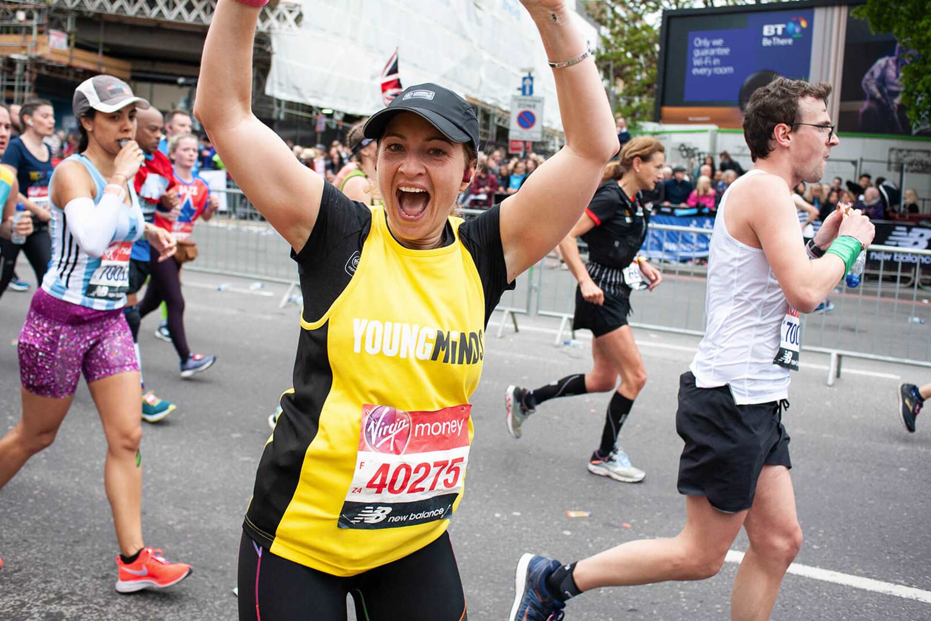 a YoungMinds supporter and runner smile to the camera to express her excitement during a running event
