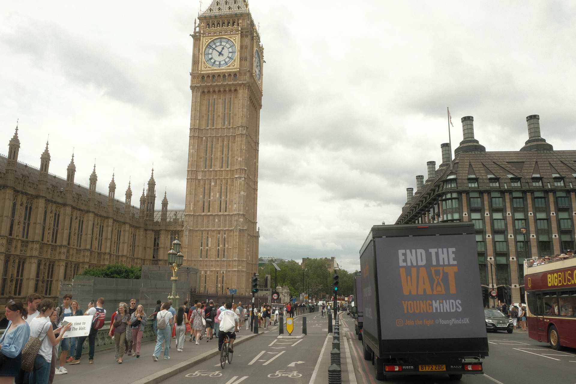 A van driving around Parliament with a sign reading: "End The Wait".