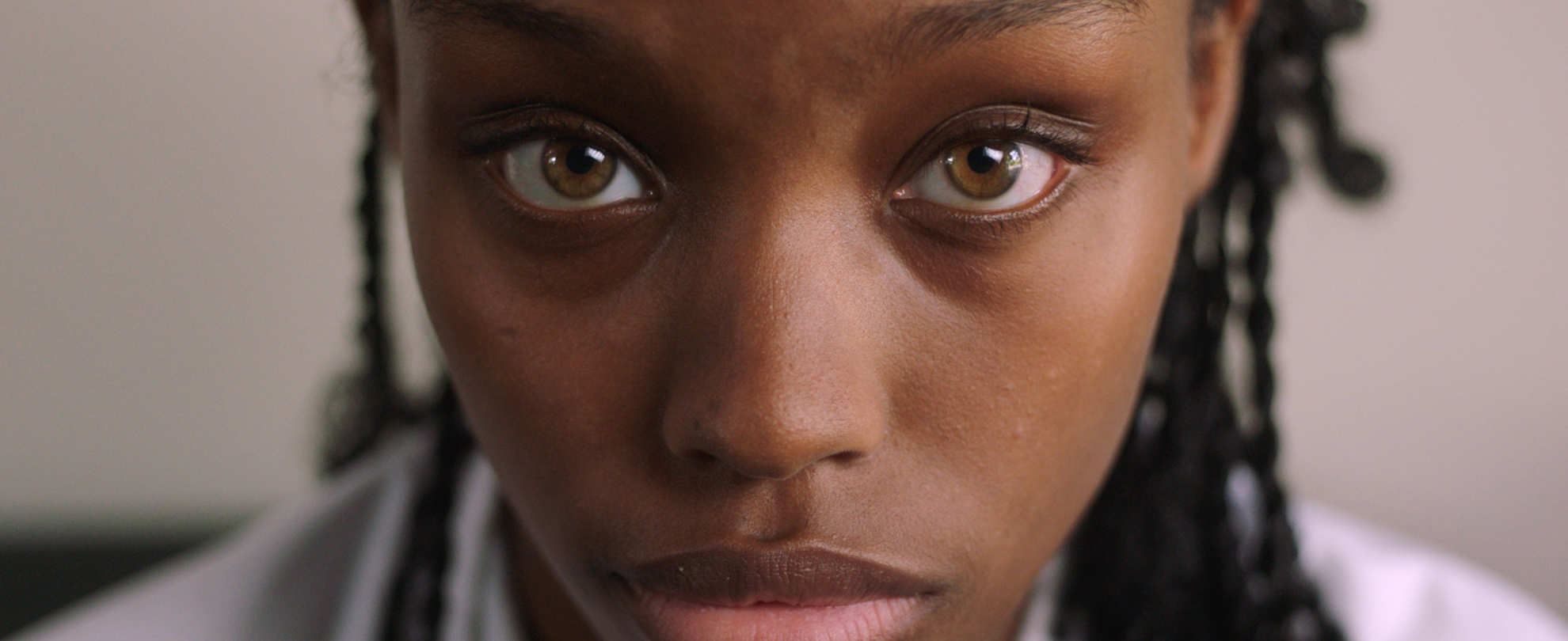 End The Wait Campaign - Close-up of a teenage girl looking at the camera