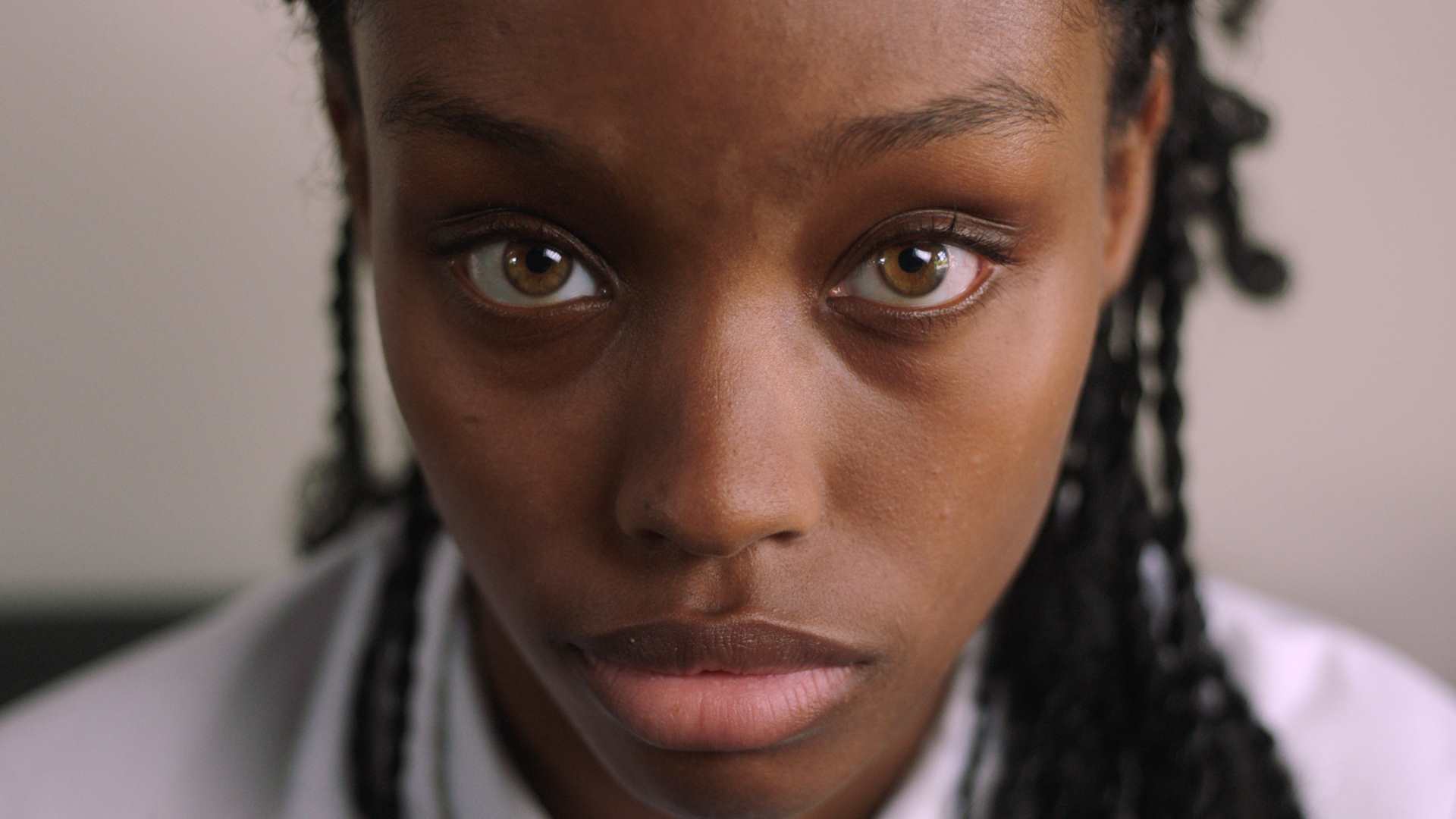 End The Wait Campaign - Close-up of a teenage girl looking at the camera