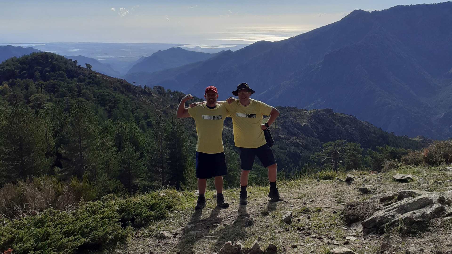 The Nicholls standing triumphantly on top of a hill.