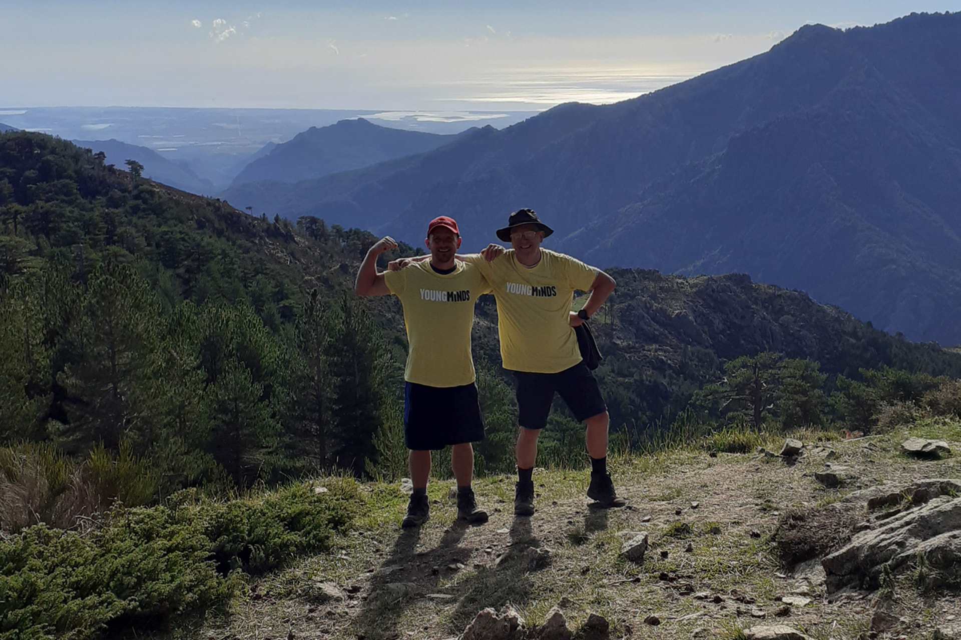 The Nicholls standing triumphantly on top of a hill.