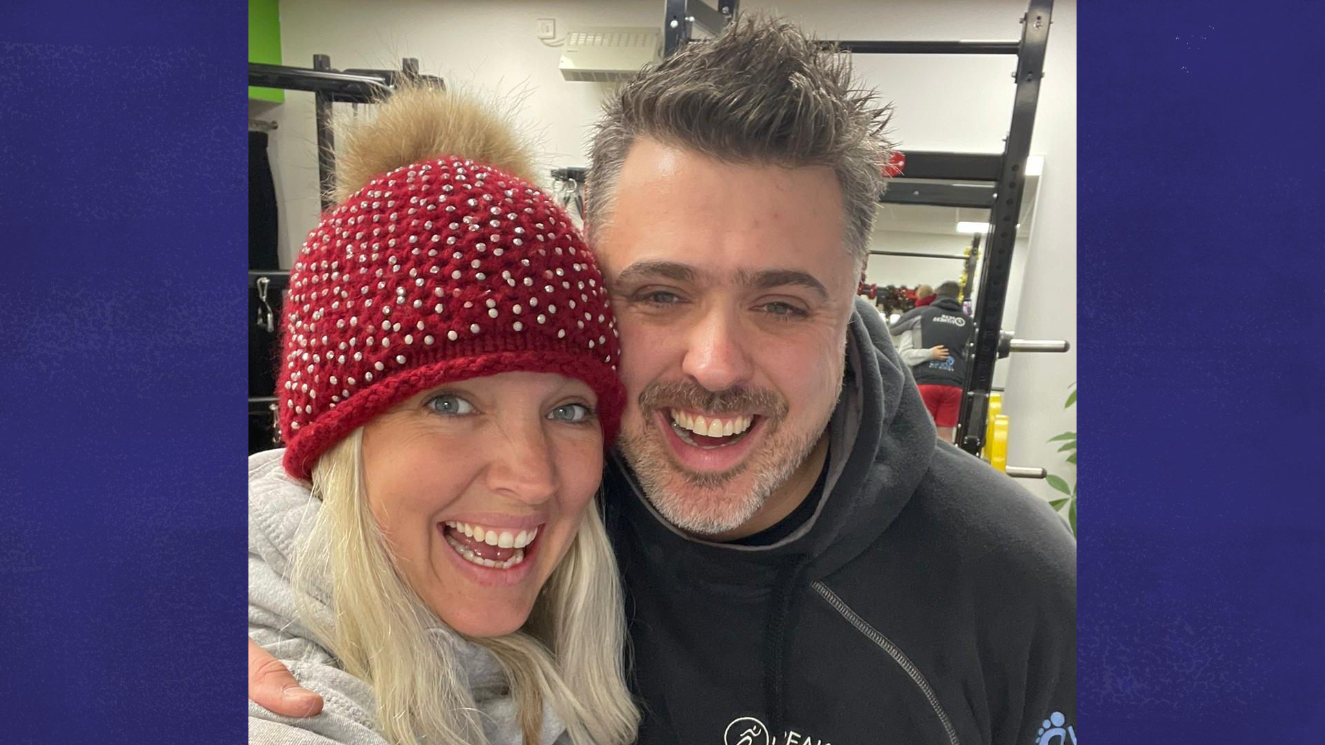 Craig and his partner standing in the gym.