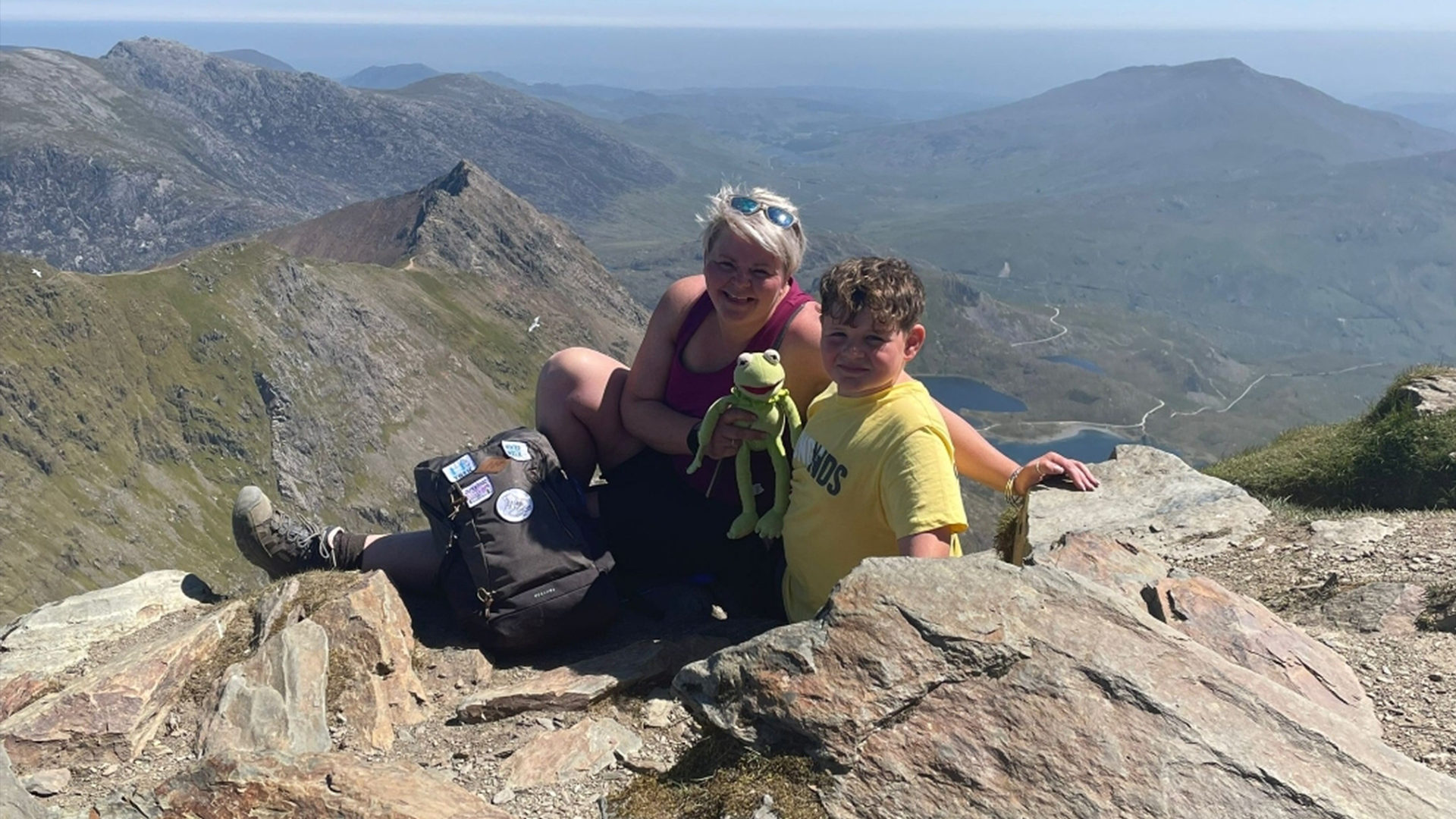 Flynn and his mum on the Snowdon mountain with a Kermit the frog toy.