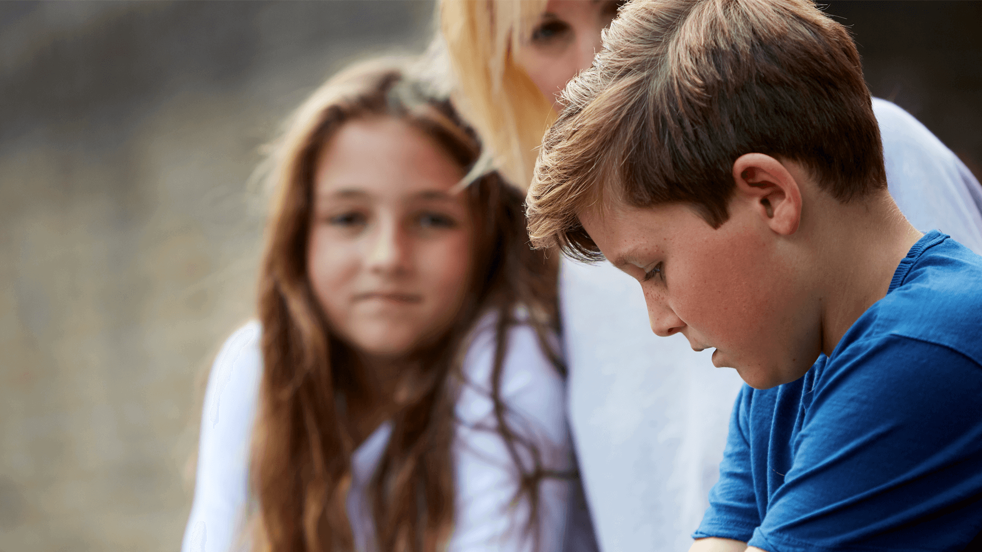 A mother talking to her son and daughter