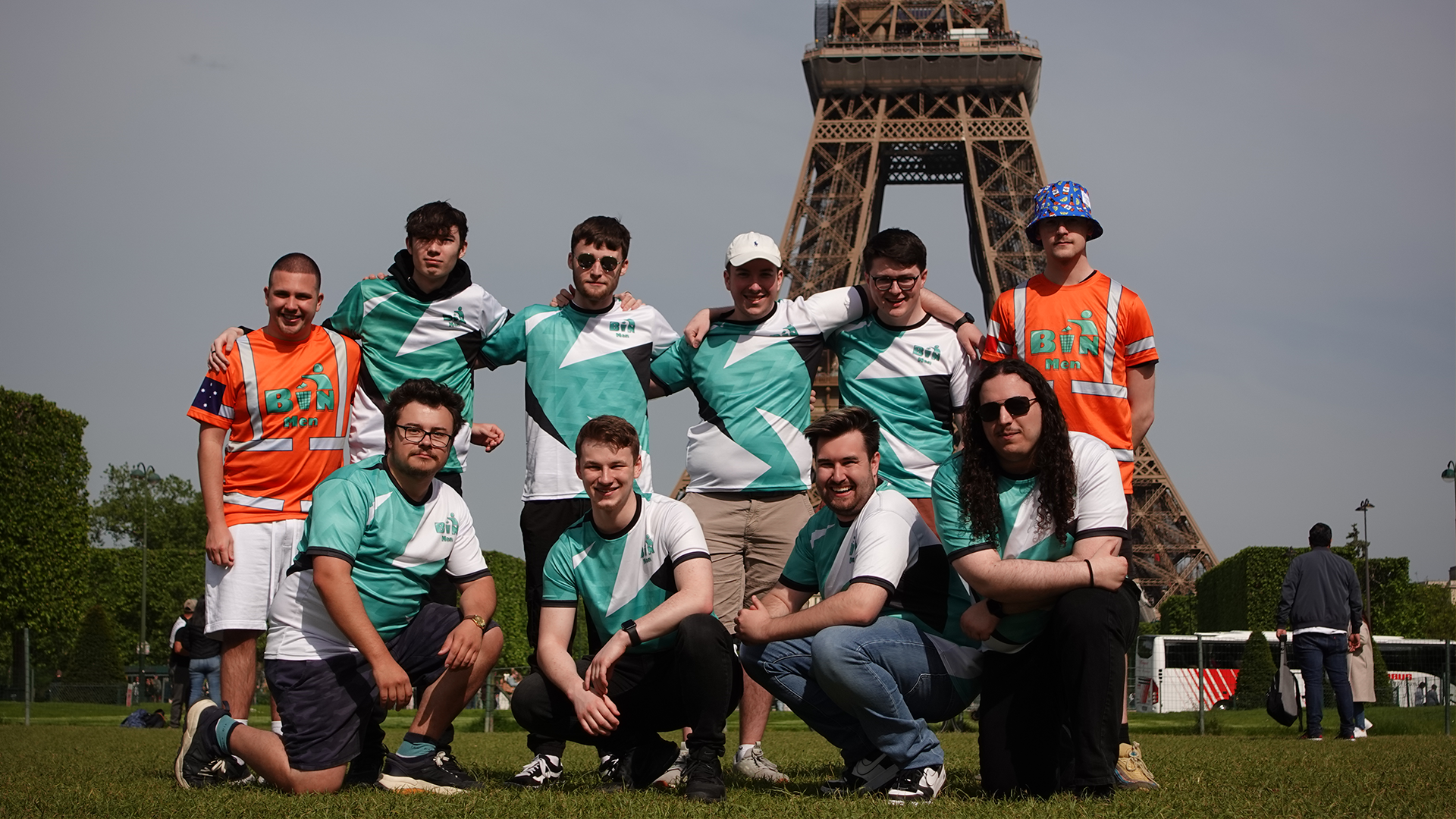 The Binmen with their arms around each other in front of the Eiffel Tower.