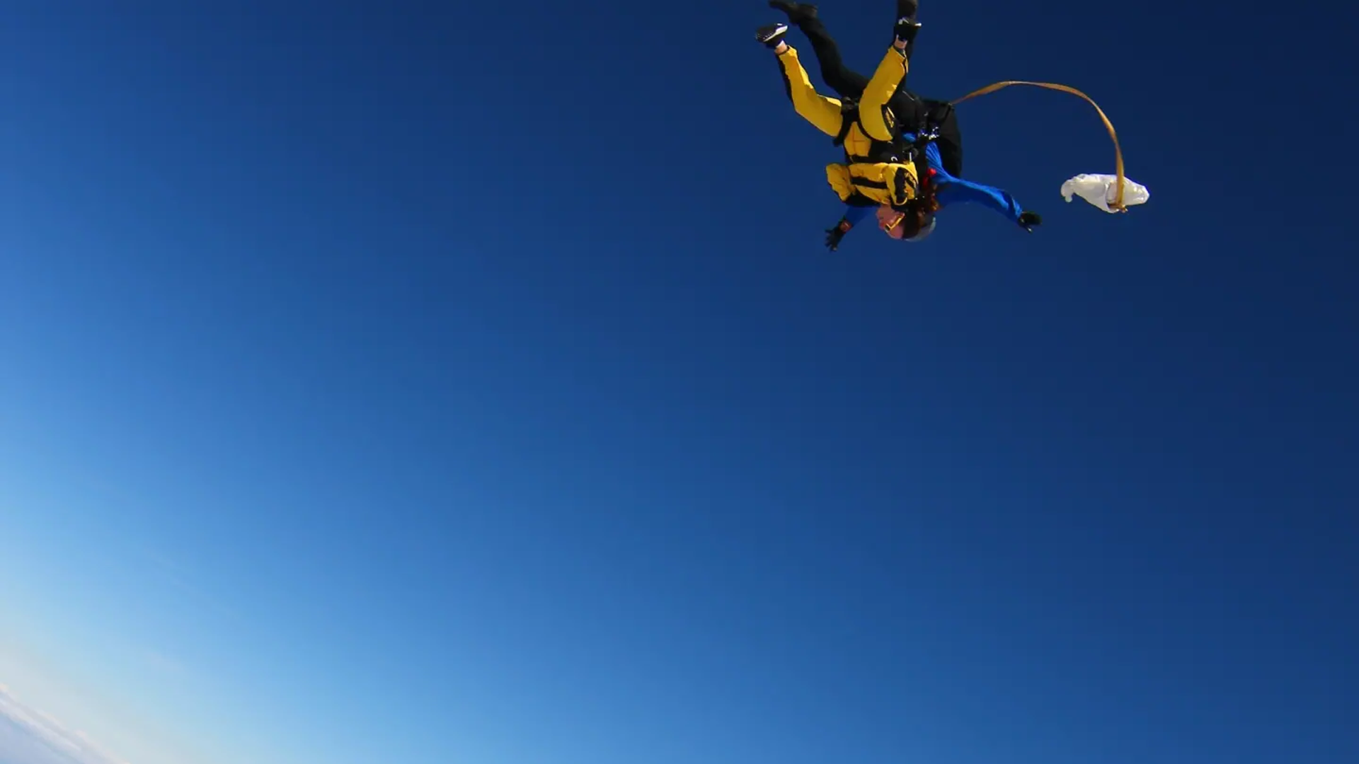 Our fundraiser Laura skydiving above the clouds.