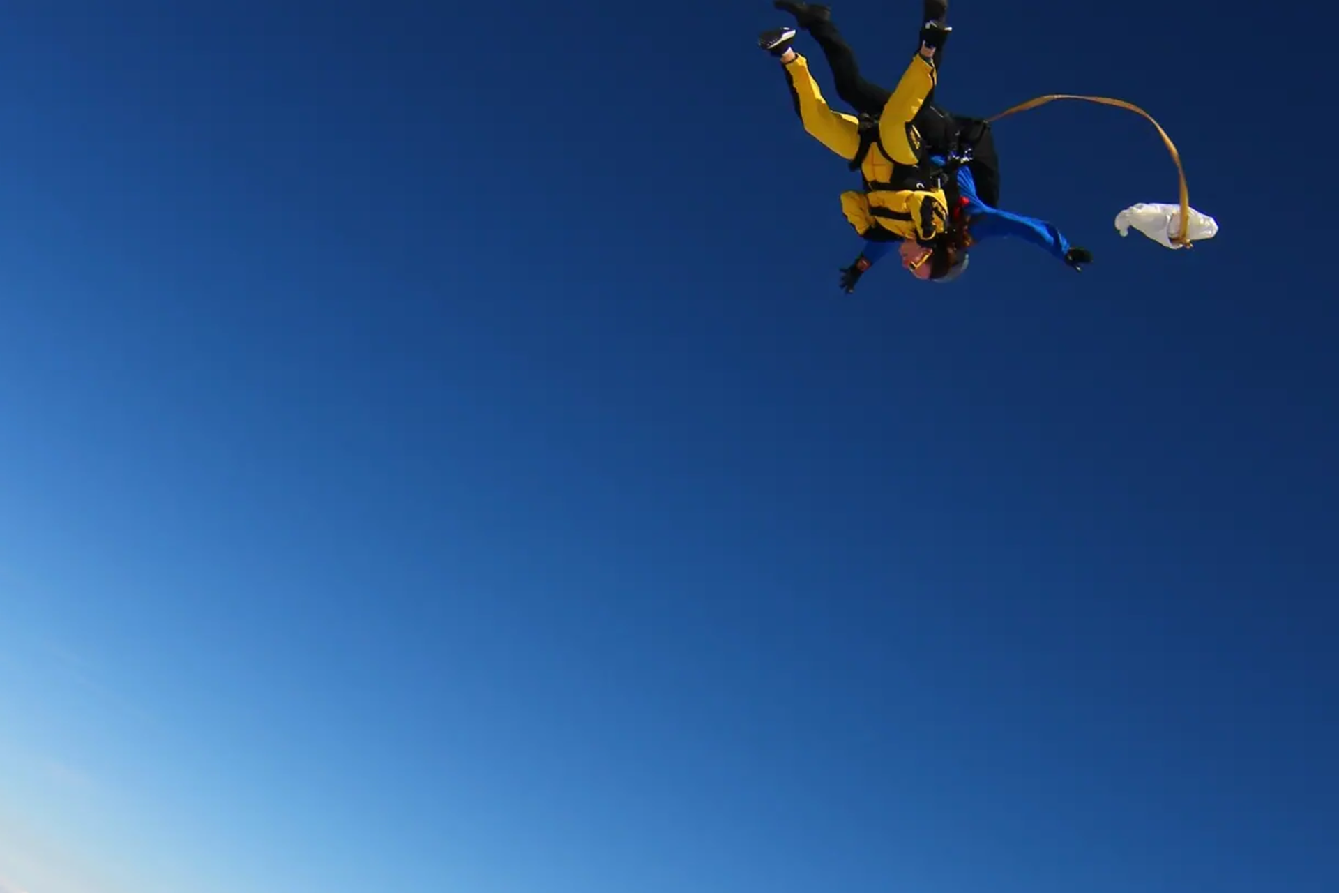 Our fundraiser Laura skydiving above the clouds.