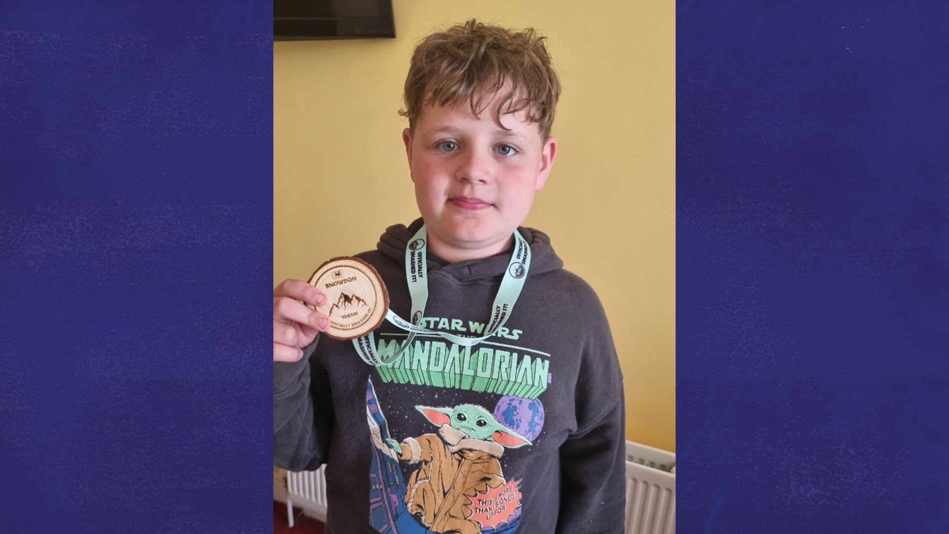 Flynn holding up his Snowdon medal.