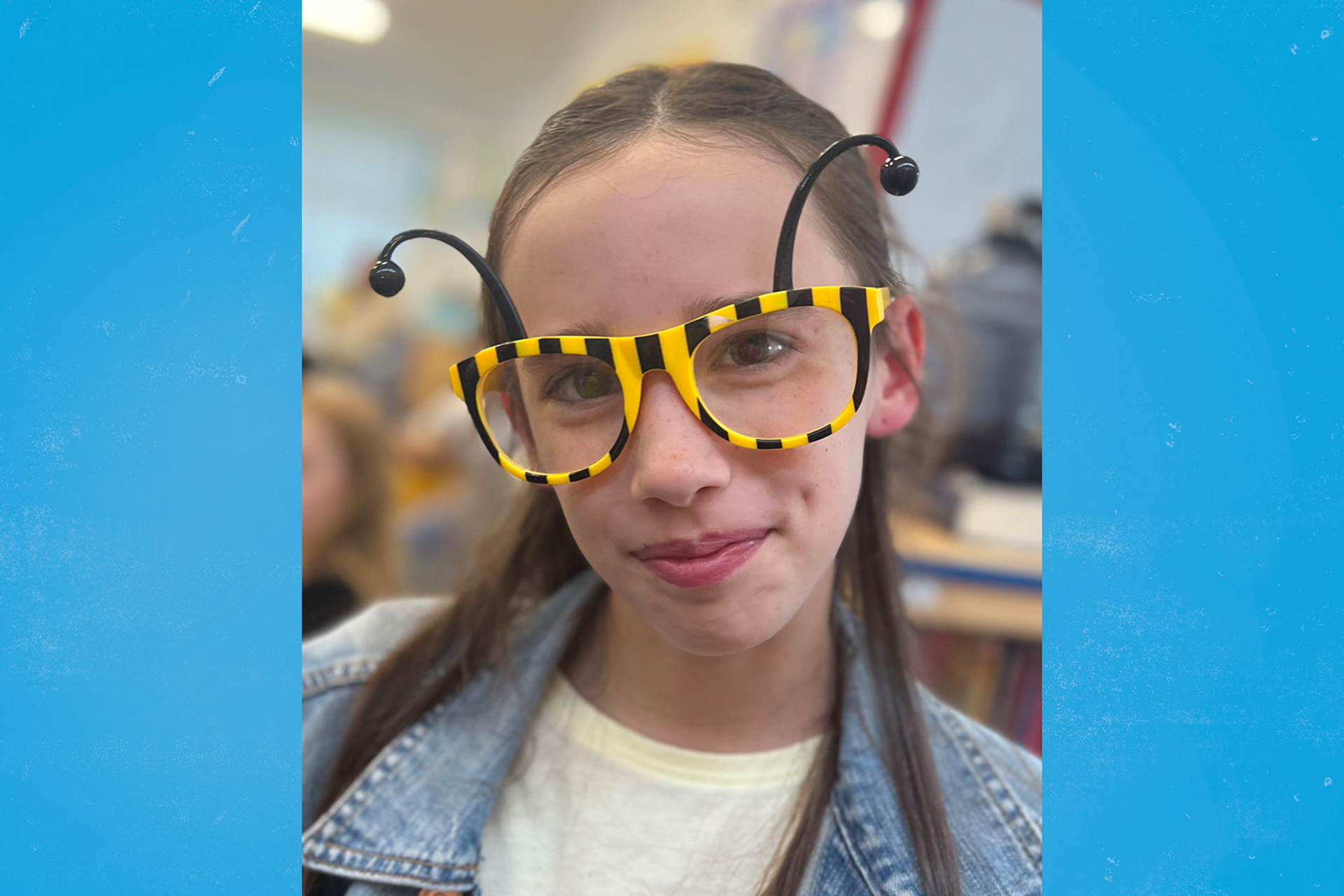 A child from East Morton CE Primary School wearing yellow and black bumblebee glasses.