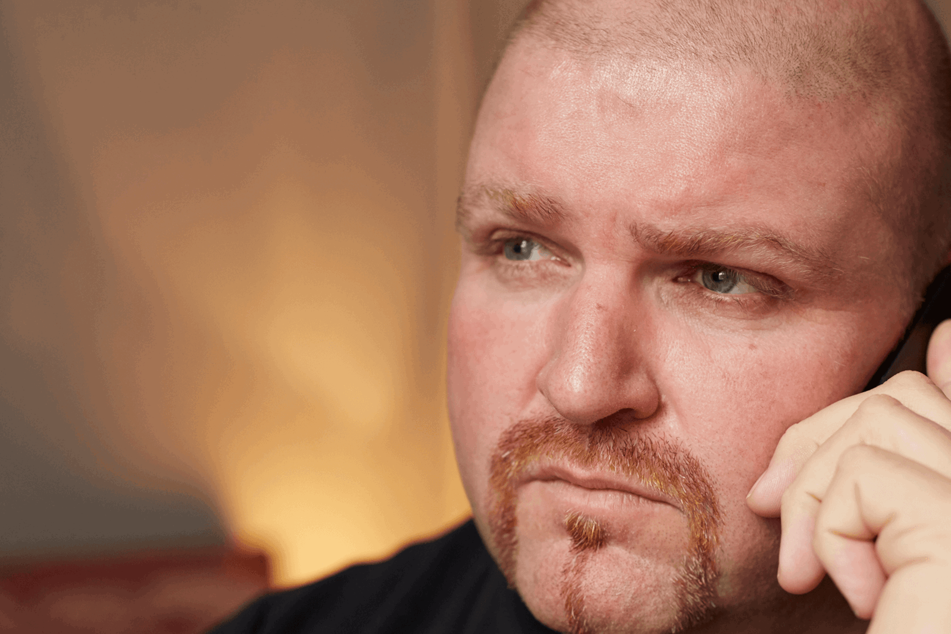 A man speaking on his mobile phone looking serious