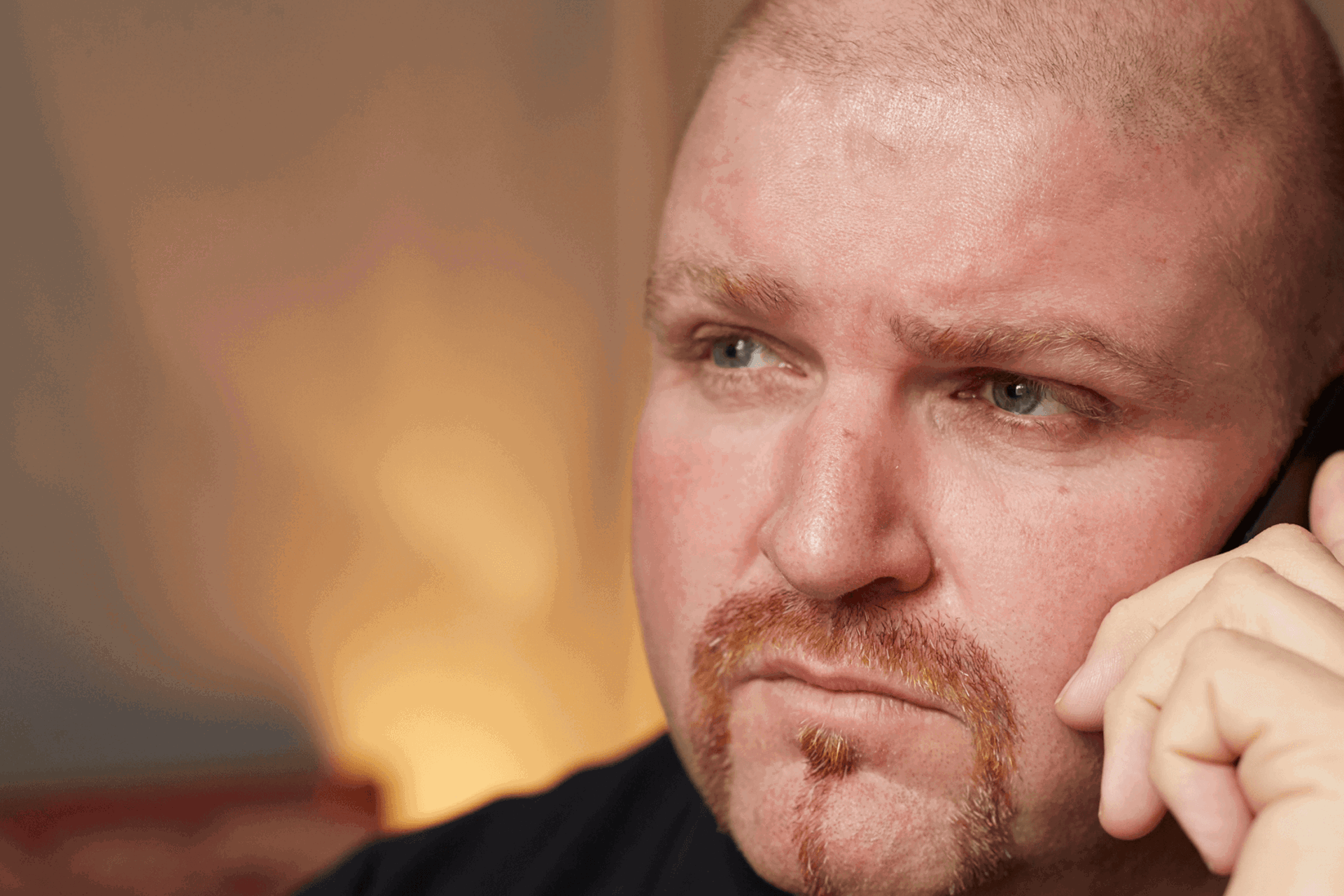 A man speaking on his mobile phone looking serious