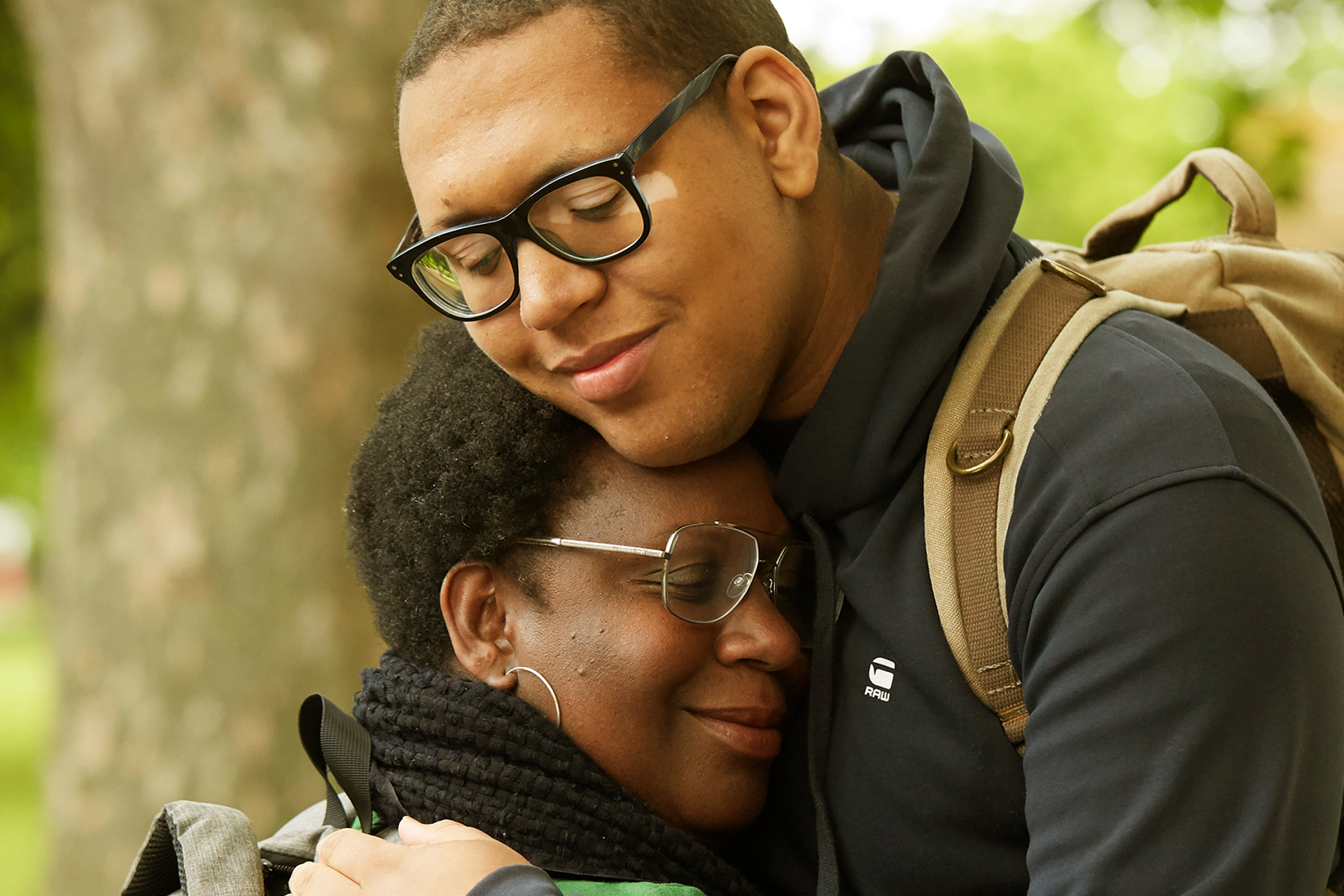 A mother and son hugging.