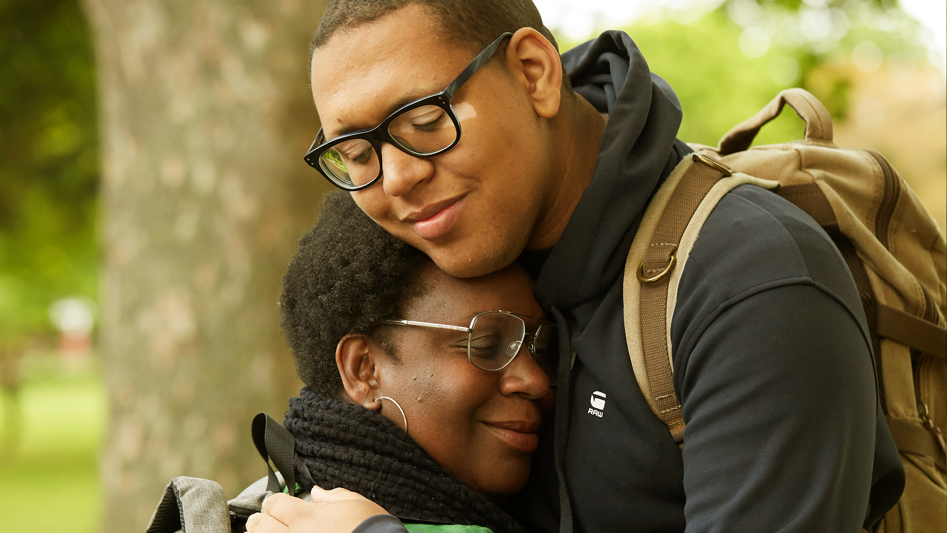 A mother and son hugging.