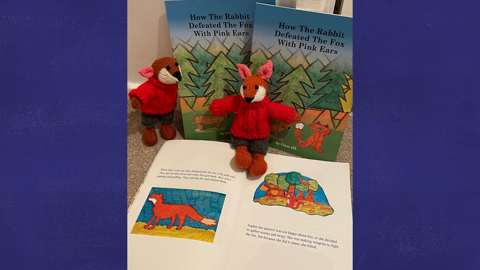 Class 6CJ's book open with two toy foxes in front of it.