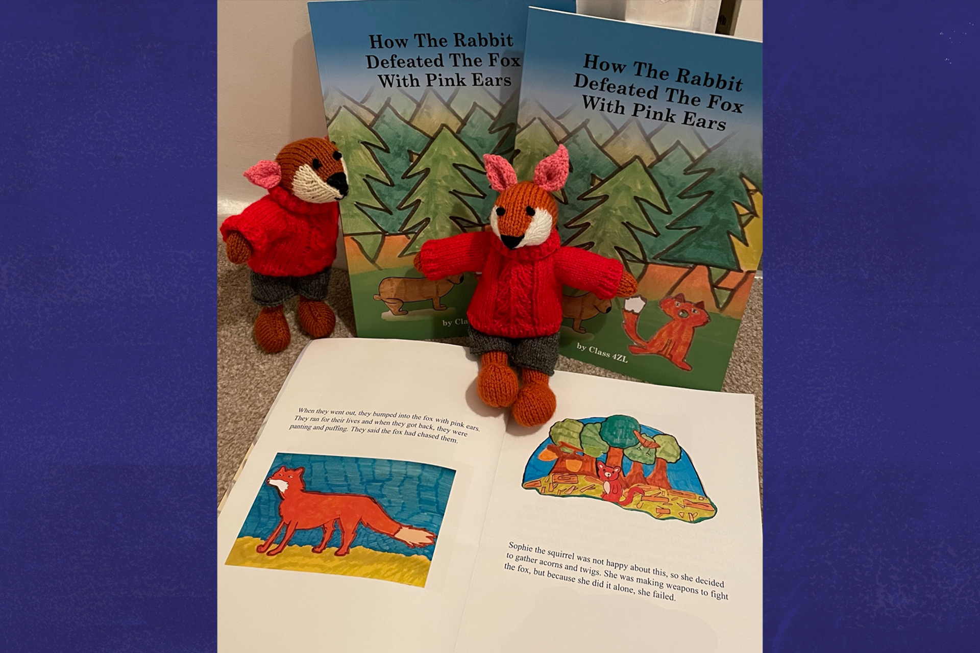 Class 6CJ's book open with two toy foxes in front of it.