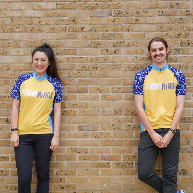 girl and boy smiling while wearing YoungMinds cycling jersey