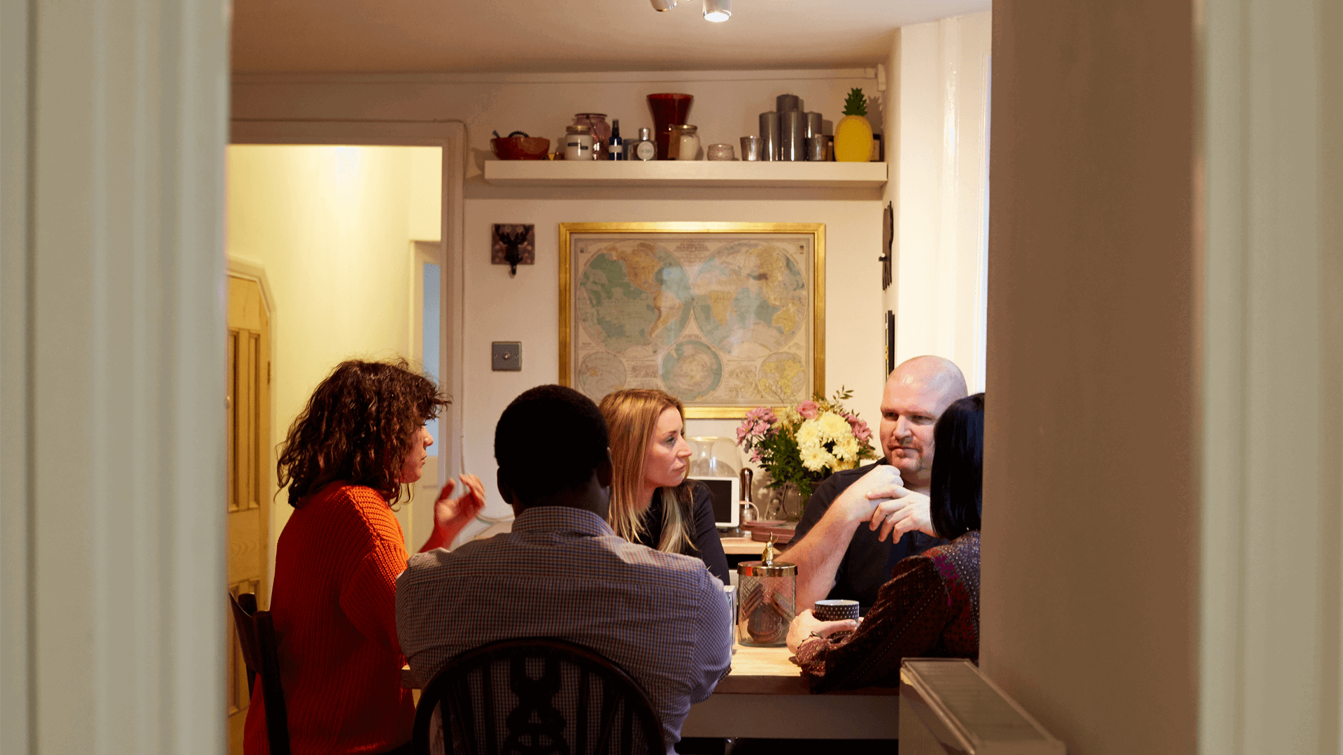 A group of people around a dinner table in conversation