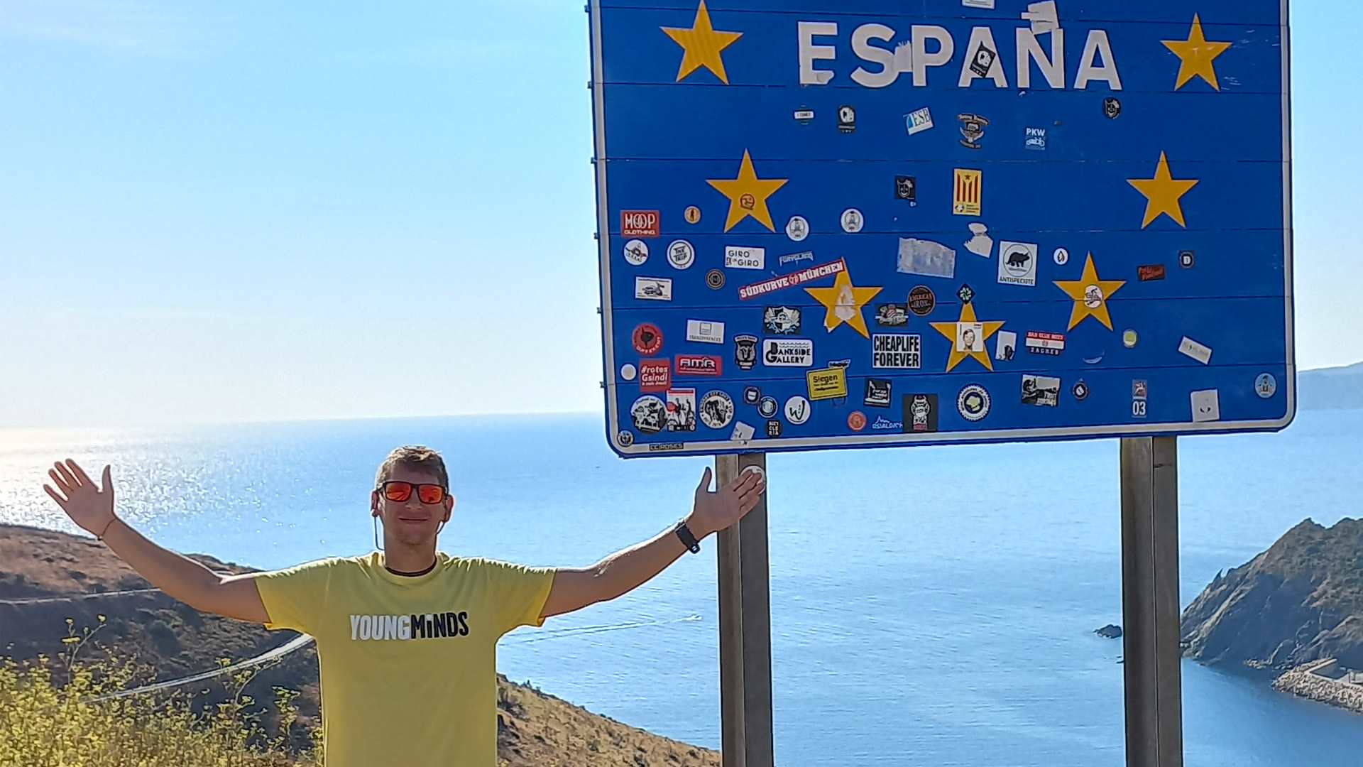Our fundraiser, Michael Evans, standing on the mountainside in Spain next to a large sign reading: España.
