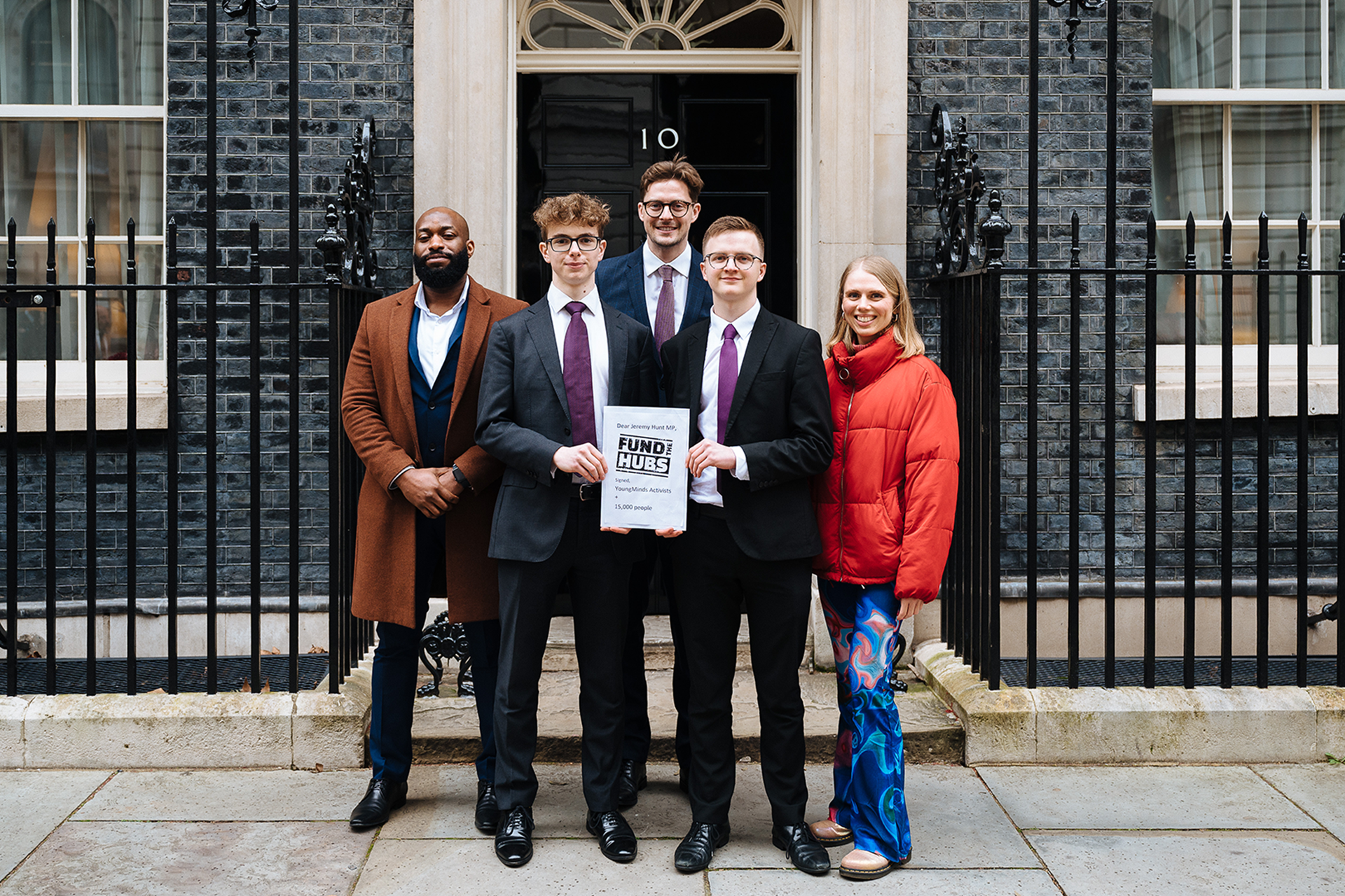 Activists stand in front of Number 10 Downing Street with their letter for Jeremey Hunt.