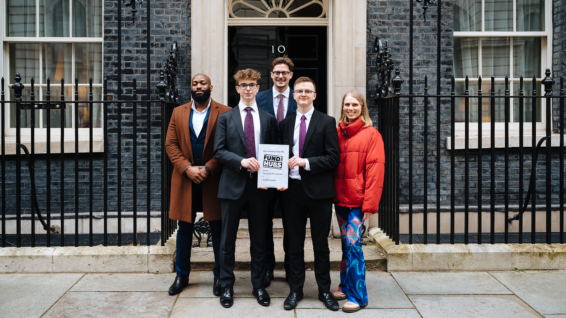 Activists stand in front of Number 10 Downing Street with their letter for Jeremey Hunt.