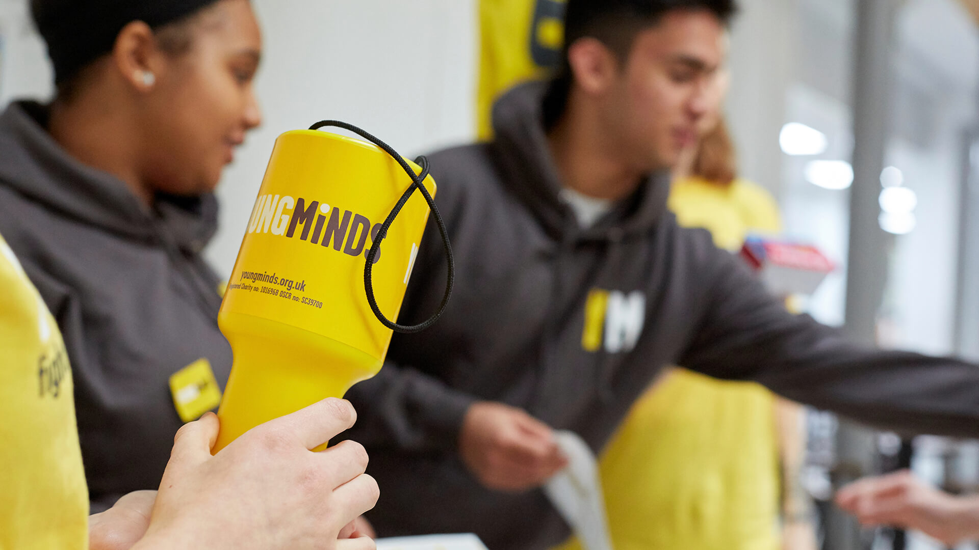 medium shot of a YoungMind Fundraising materials with volunteers busy at the background