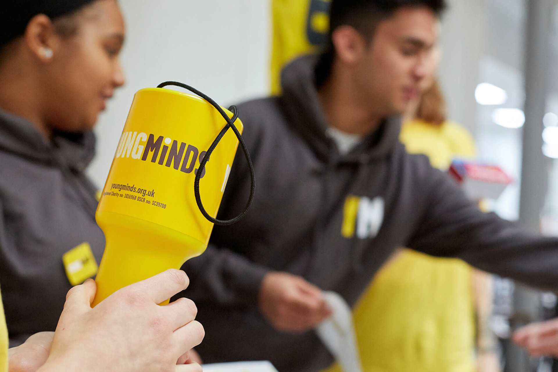 medium shot of a YoungMind Fundraising materials with volunteers busy at the background