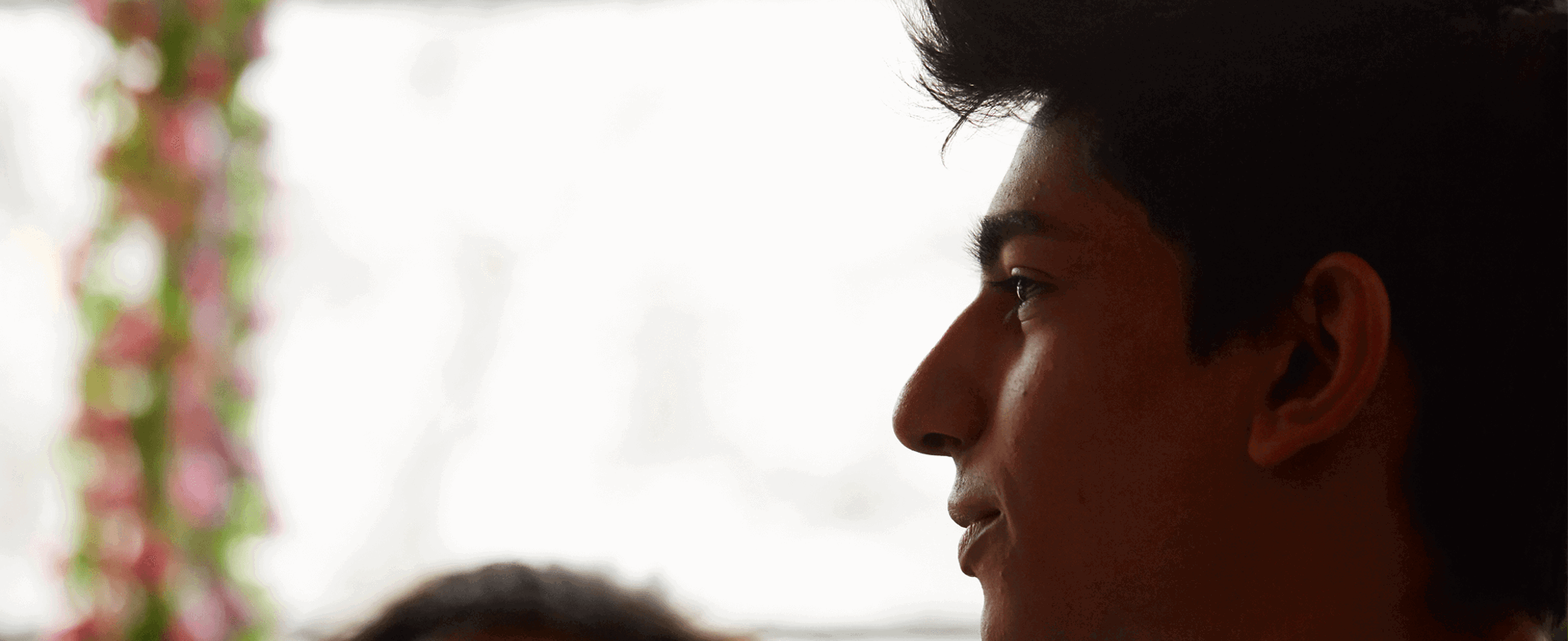 close-up-of-a-boy-looking-away-with-window-on-background